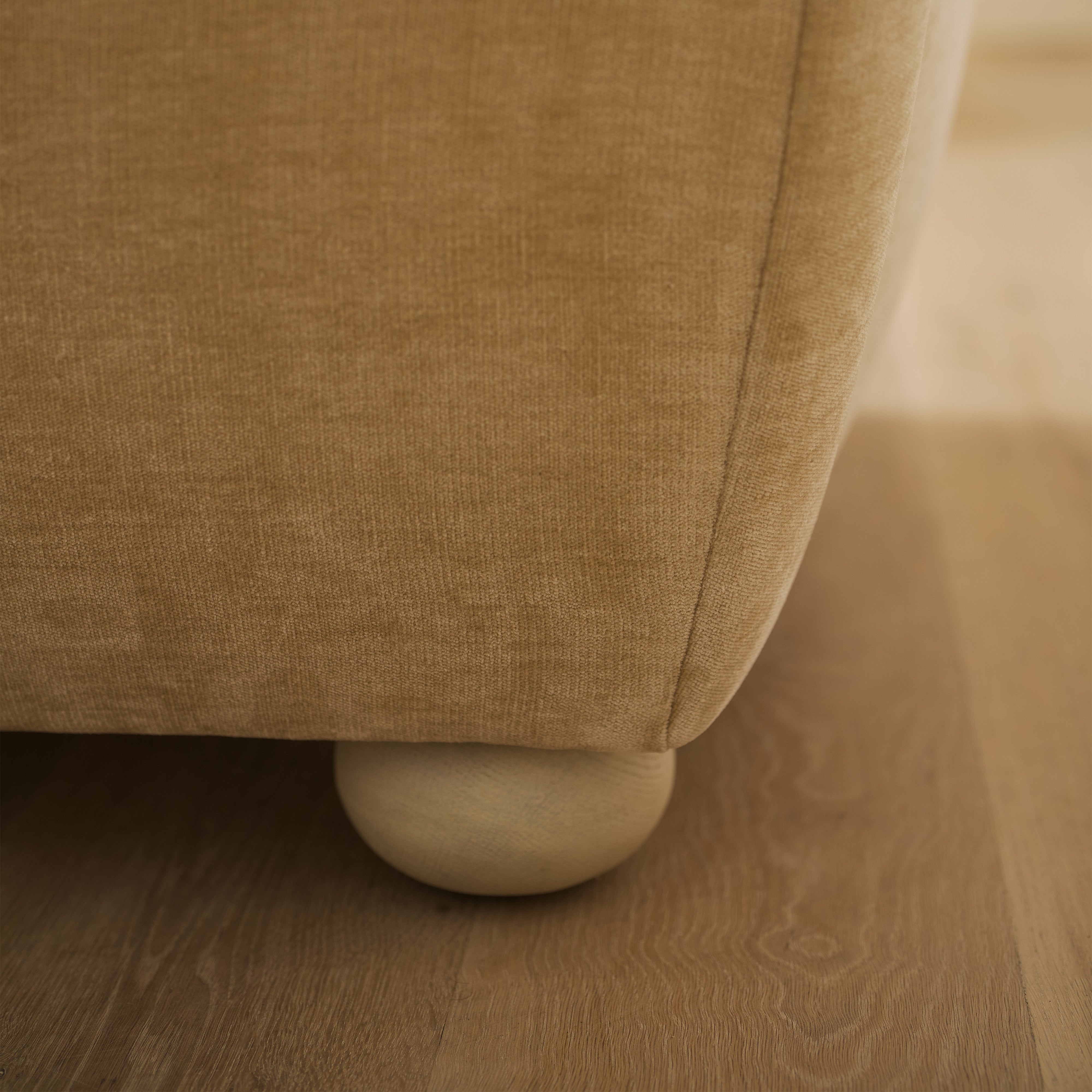 As shown upholstered in Canyon Sand, legs in Sand finish