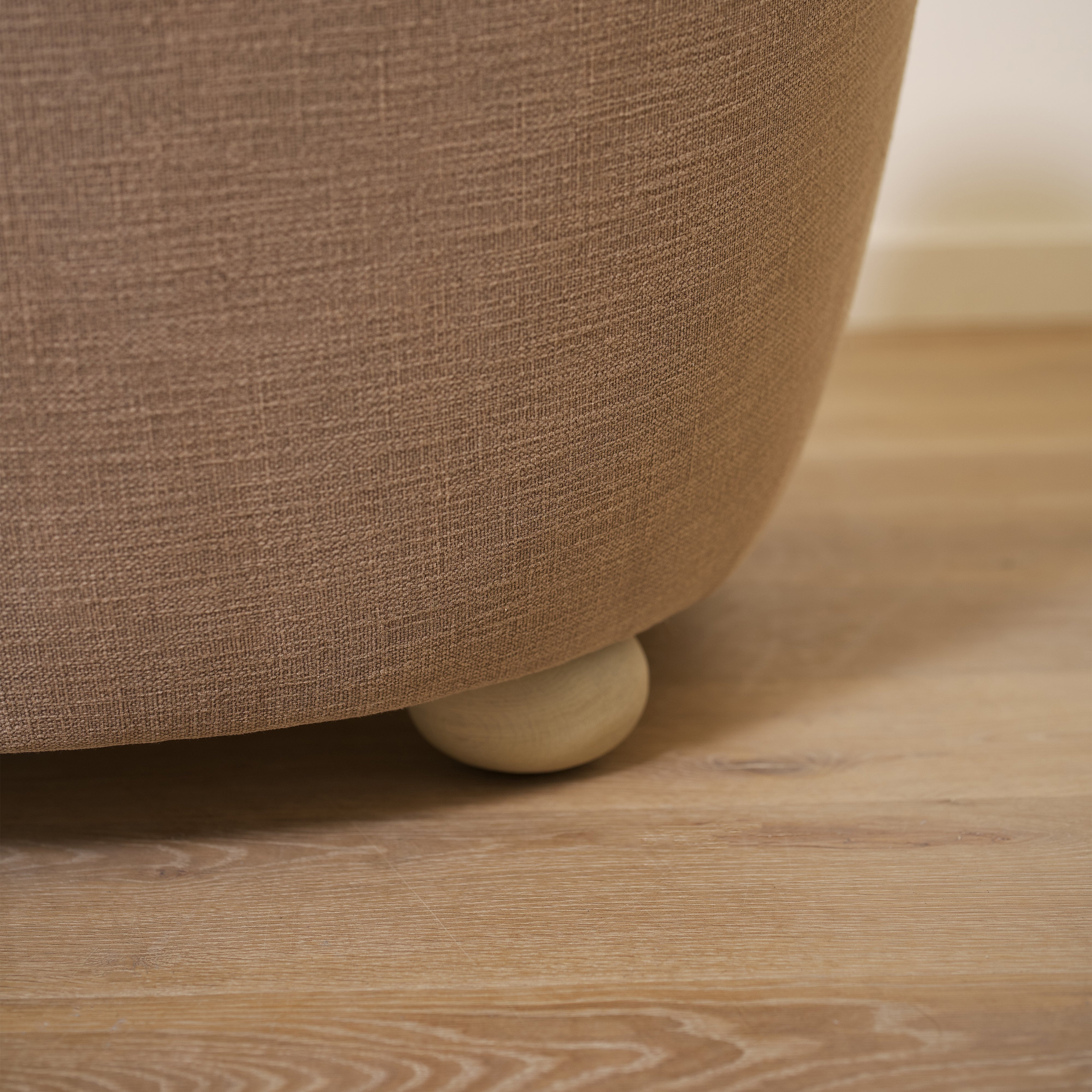 As shown upholstered in Vail Bark, legs in Sand finish