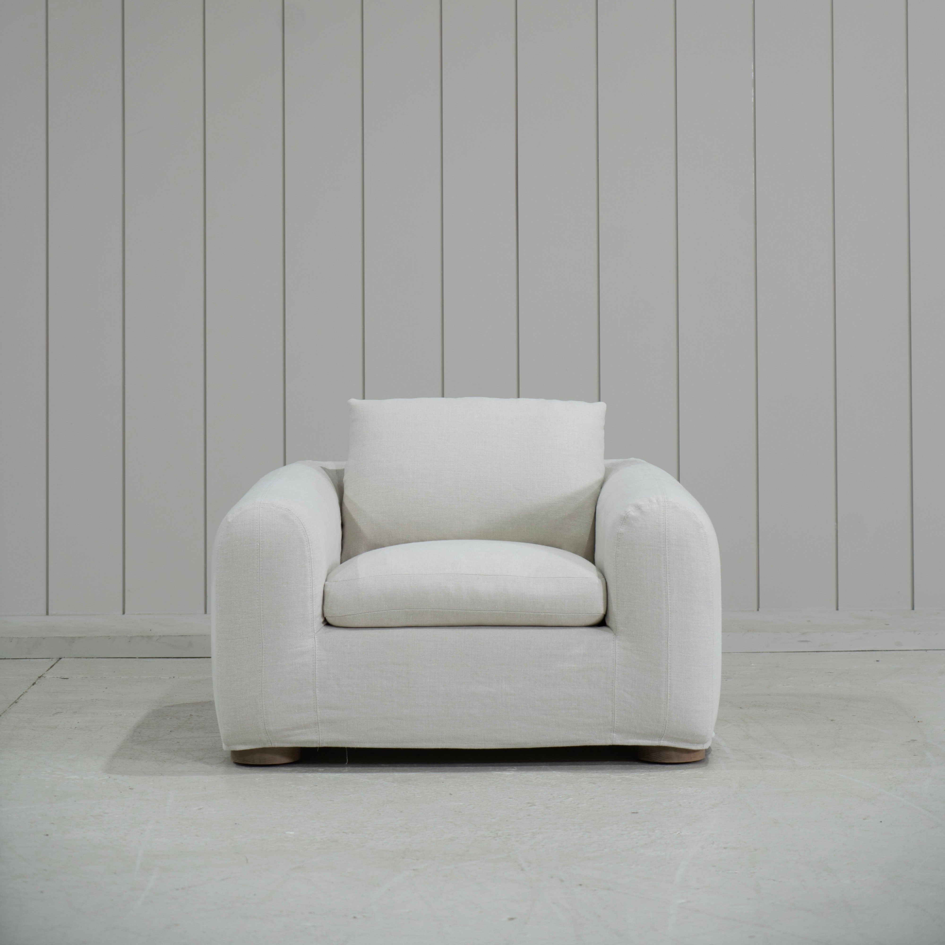 As Shown in Slipcovered Fresno Sand, Oak Round Legs finished in Cashmere Brown (Discontinued Finish)