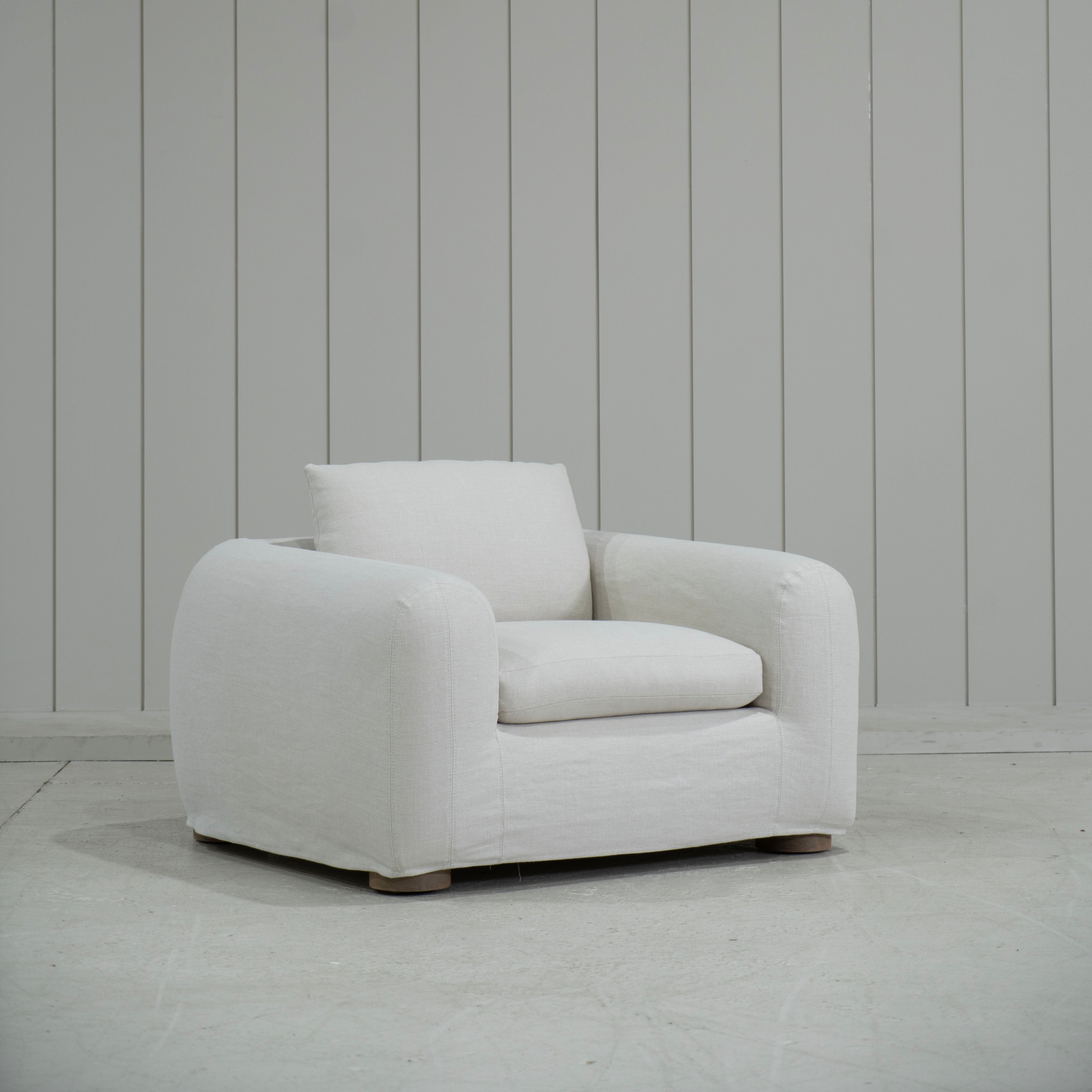 As Shown in Slipcovered Fresno Sand, Oak Round Legs finished in Cashmere Brown (Discontinued Finish)