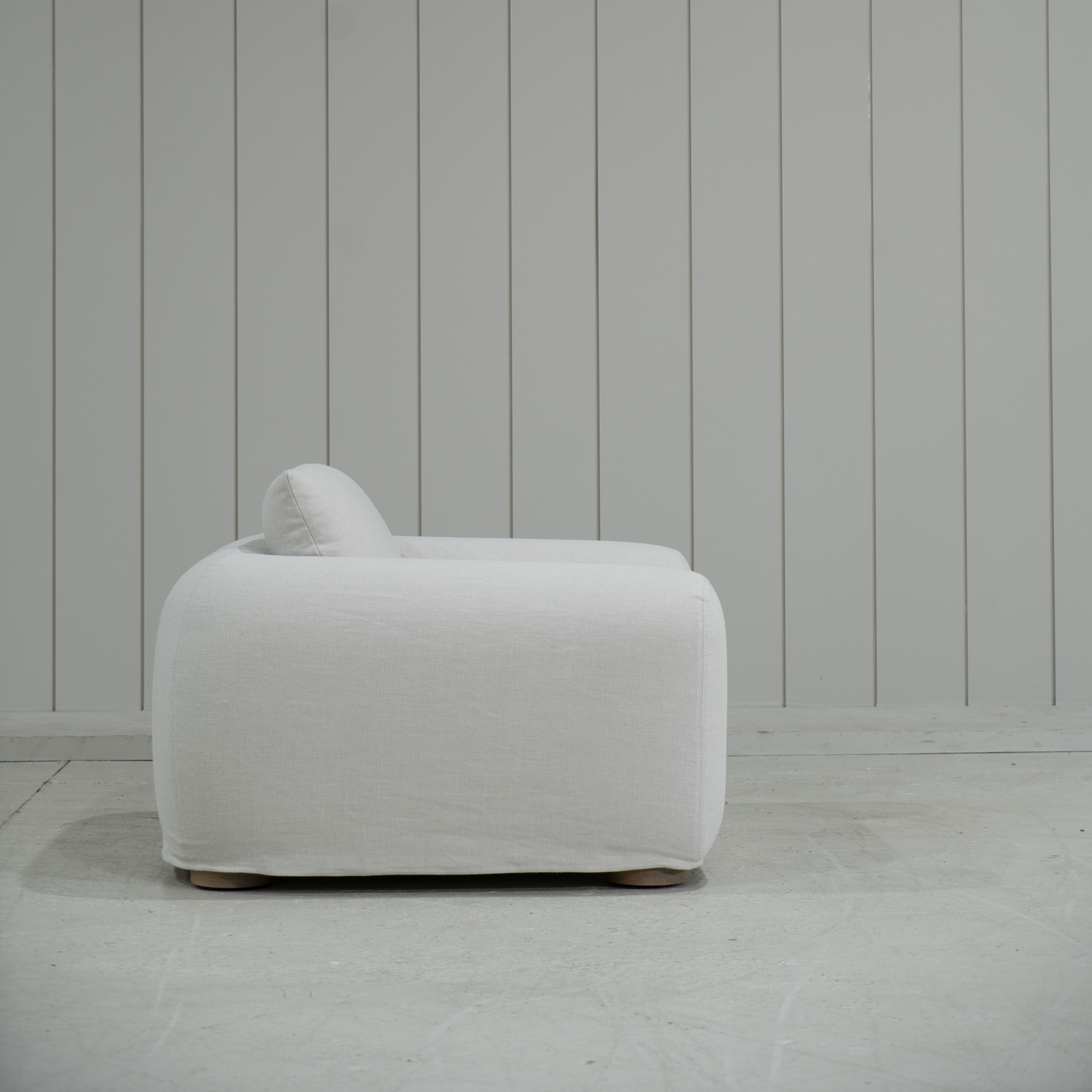 As Shown in Slipcovered Fresno Sand, Oak Round Legs finished in Cashmere Brown (Discontinued Finish)