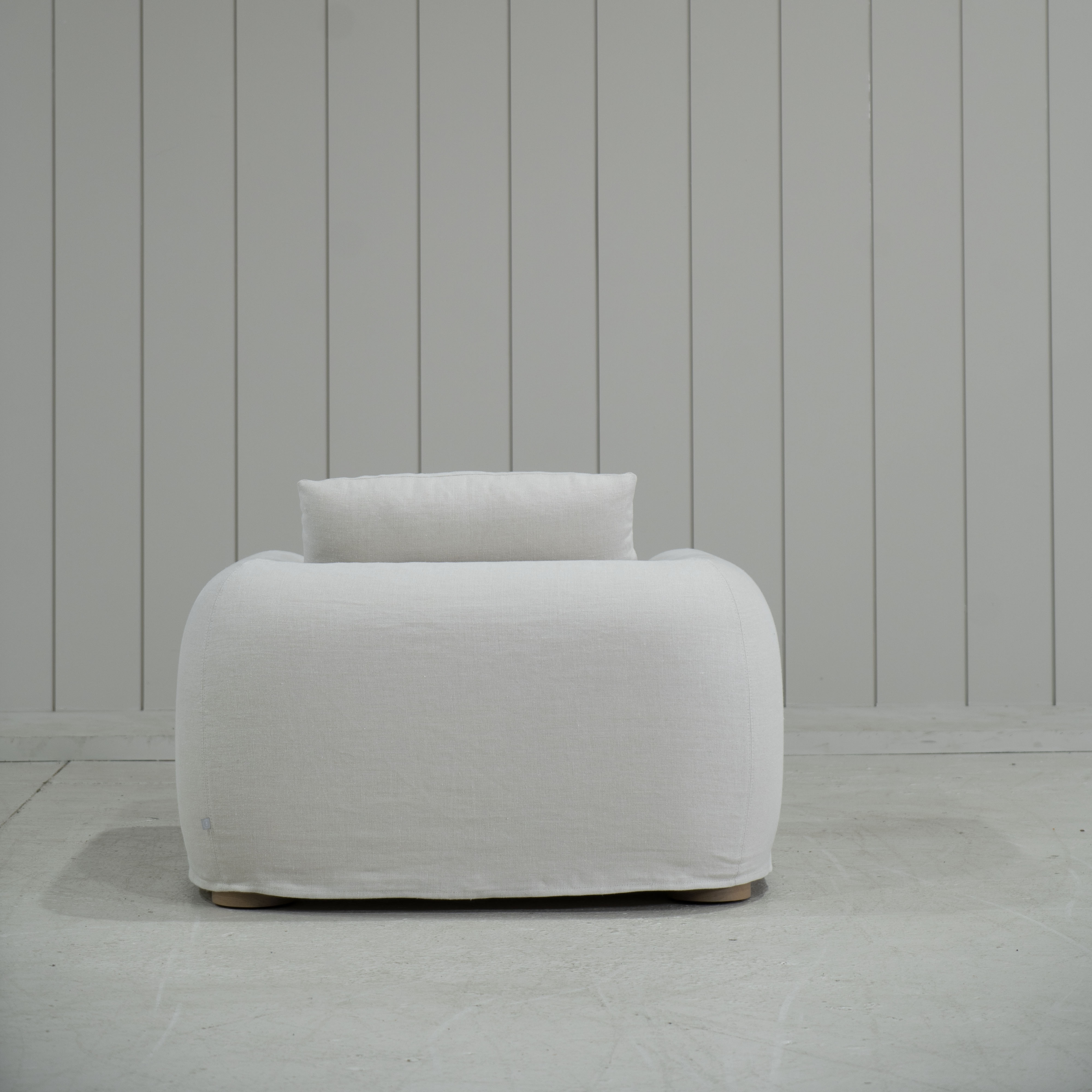 As Shown in Slipcovered Fresno Sand, Oak Round Legs finished in Cashmere Brown (Discontinued Finish)