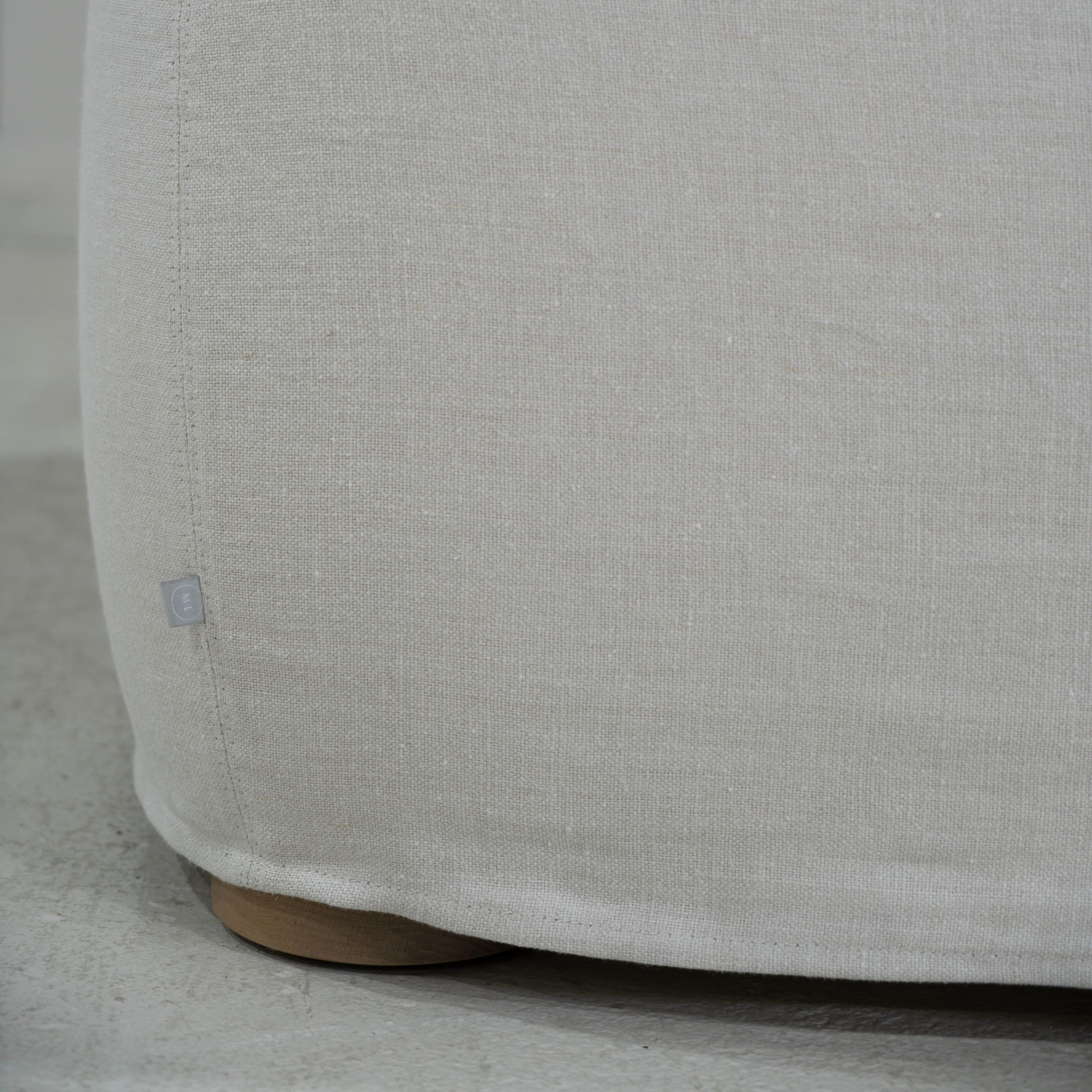 As Shown in Slipcovered Fresno Sand, Oak Round Legs finished in Cashmere Brown (Discontinued Finish)