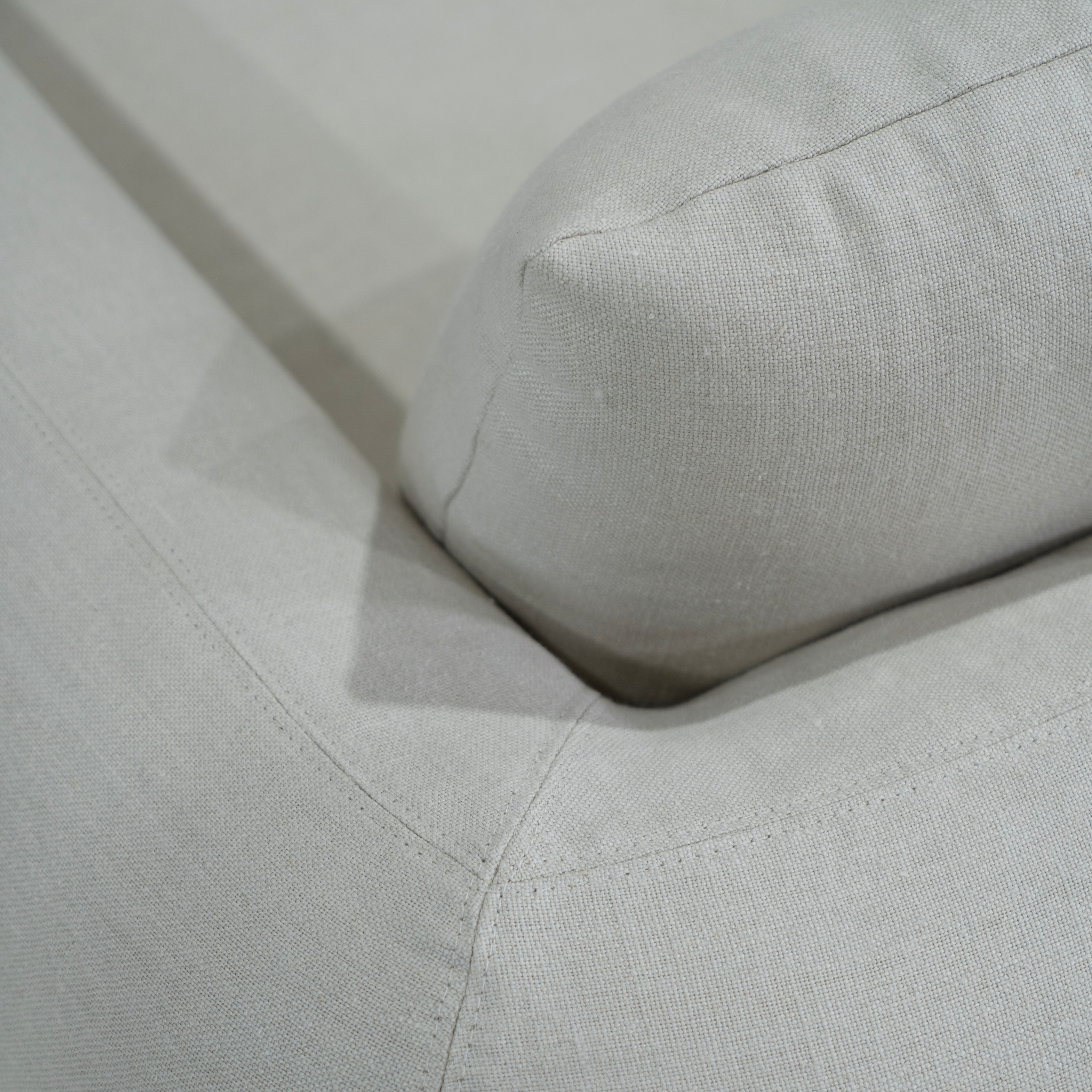 As Shown in Slipcovered Fresno Sand, Oak Round Legs finished in Cashmere Brown (Discontinued Finish)