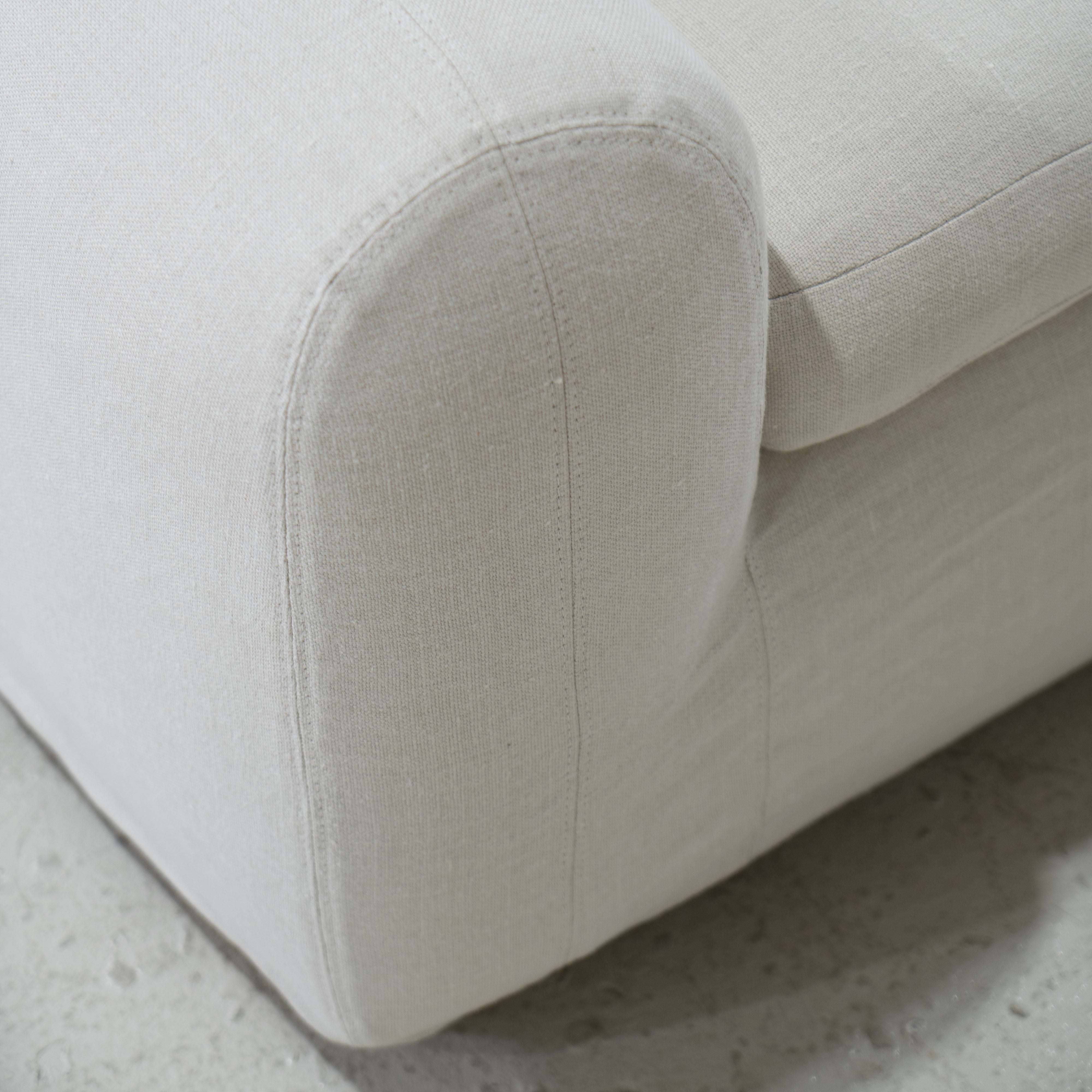 As Shown in Slipcovered Fresno Sand, Oak Round Legs finished in Cashmere Brown (Discontinued Finish)