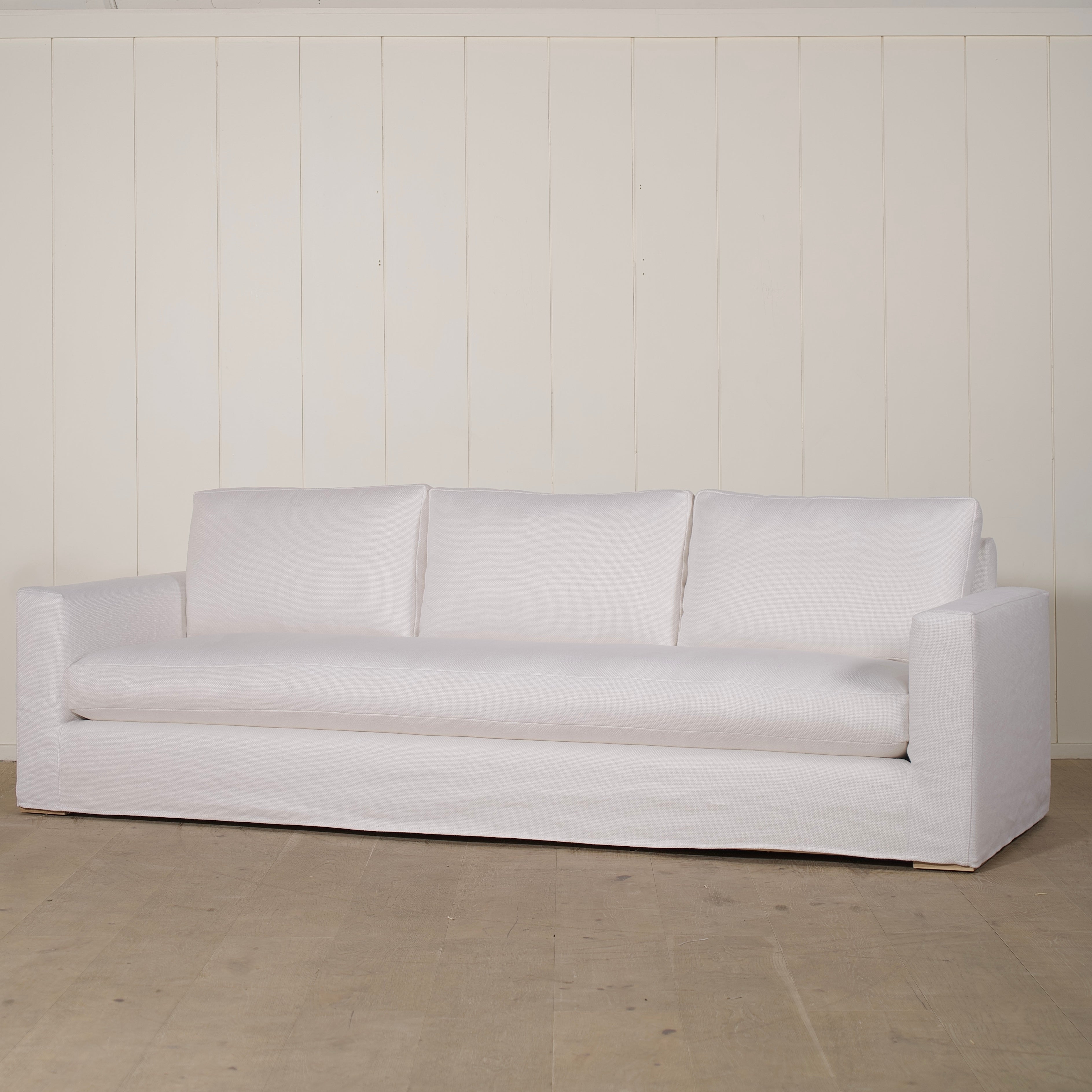 As Shown: slipcovered in COM fabric (Monte White), oak legs finished in Mint White Natural.