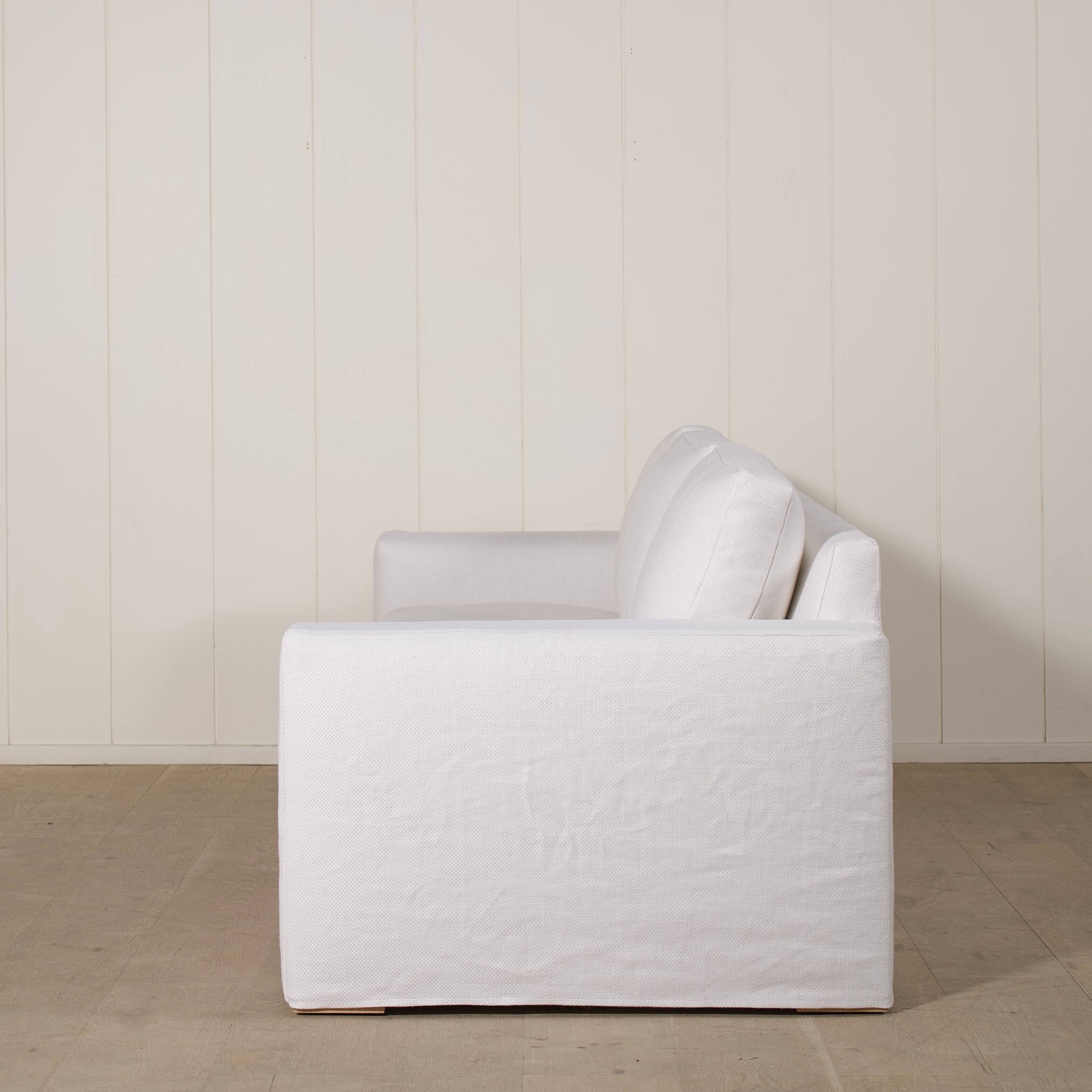 As Shown: slipcovered in COM fabric (Monte White), oak legs finished in Mint White Natural.