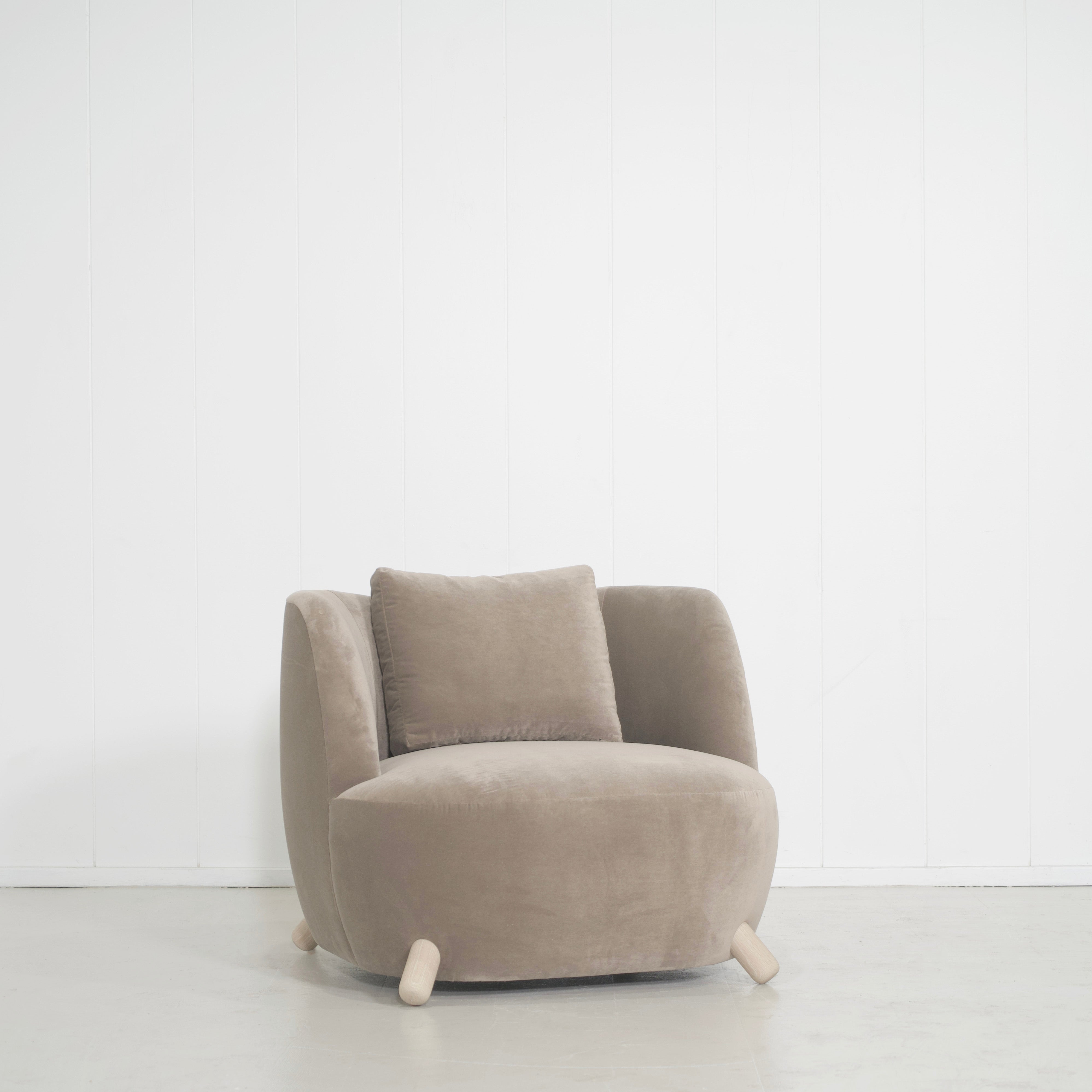 As Shown: in Sky Taupe with oak legs stained in Sand.