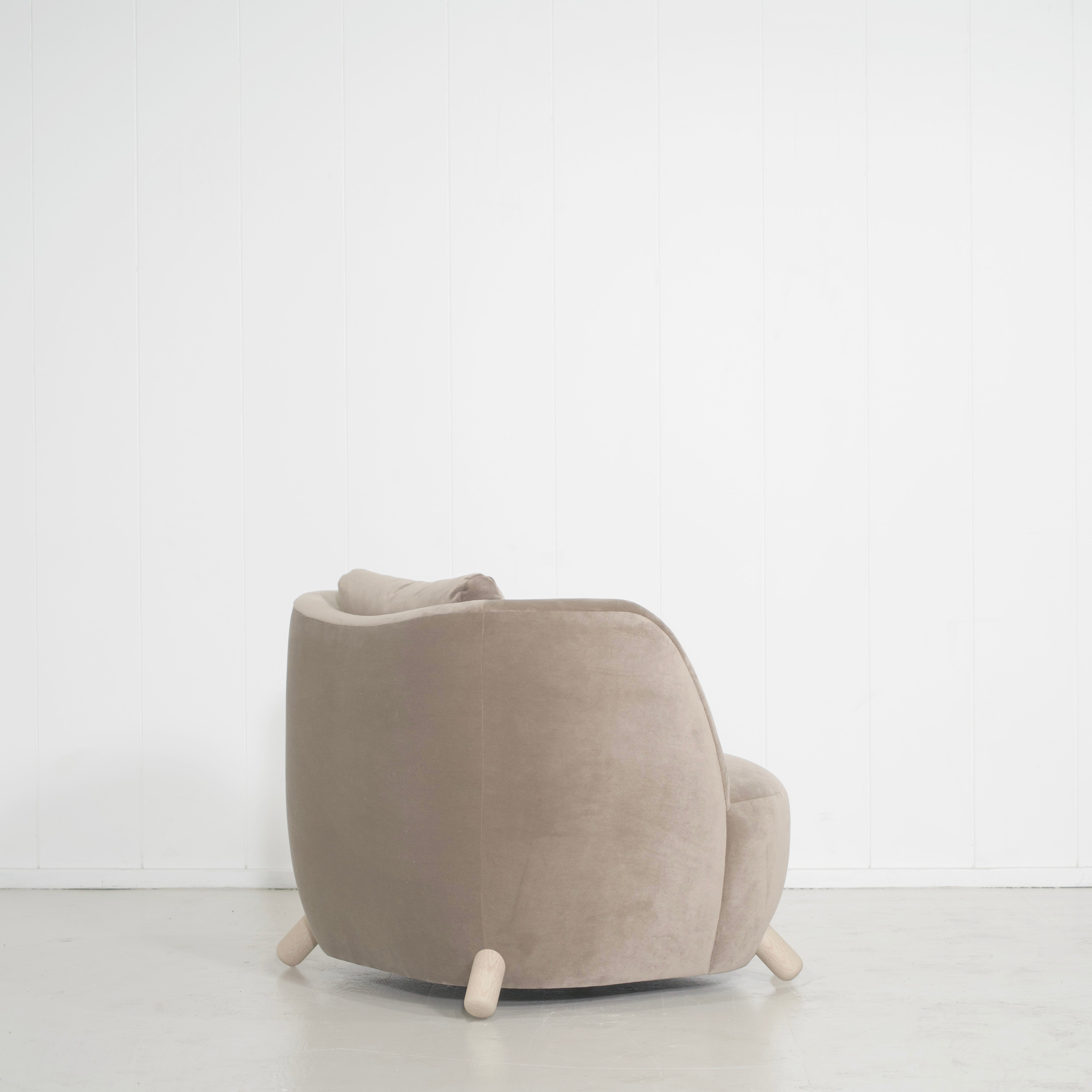 As Shown: in Sky Taupe with oak legs stained in Sand.