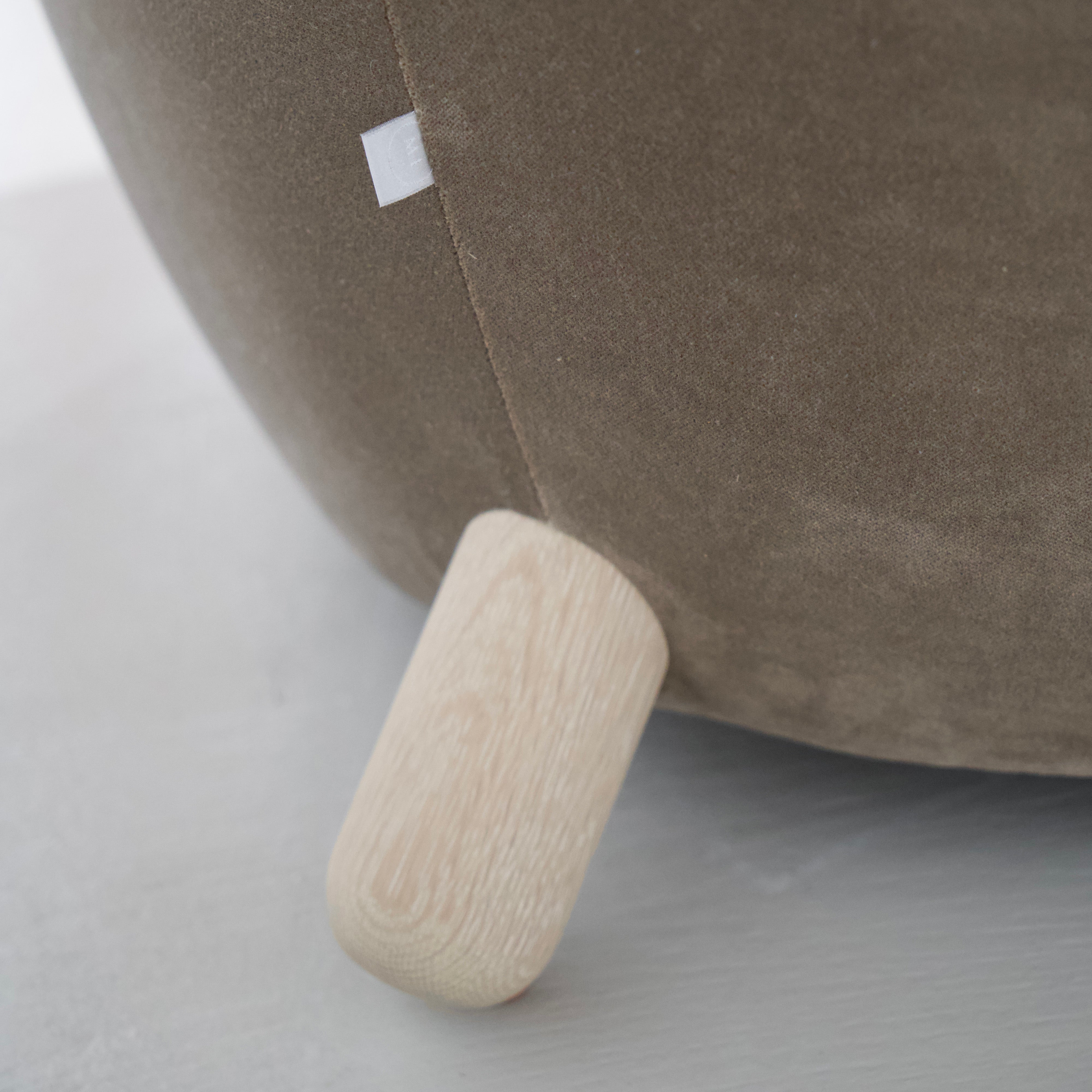 As Shown: in Sky Taupe with oak legs stained in Sand.