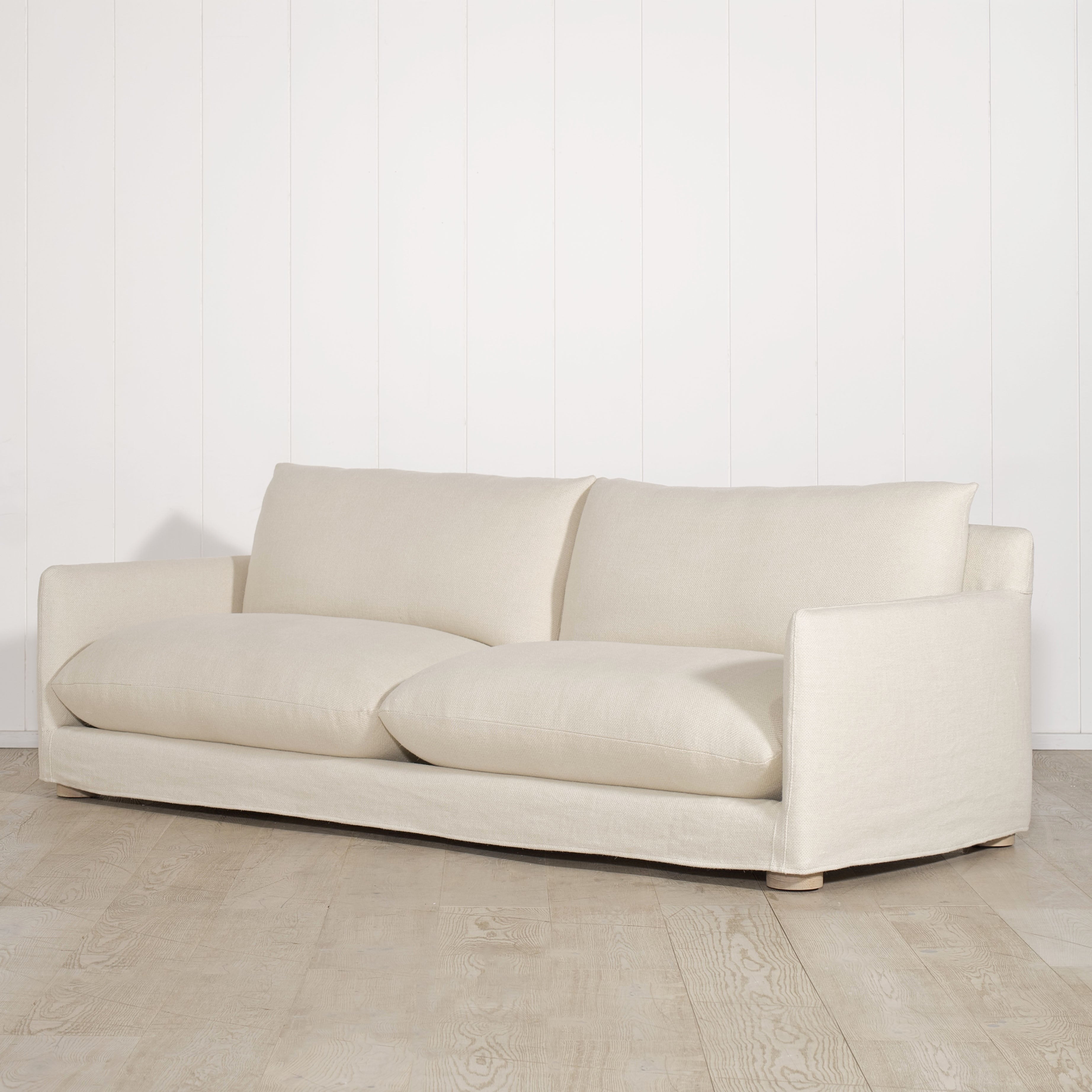 As Shown: Slipcovered in Monte Natural with legs finishing in Mint White Natural