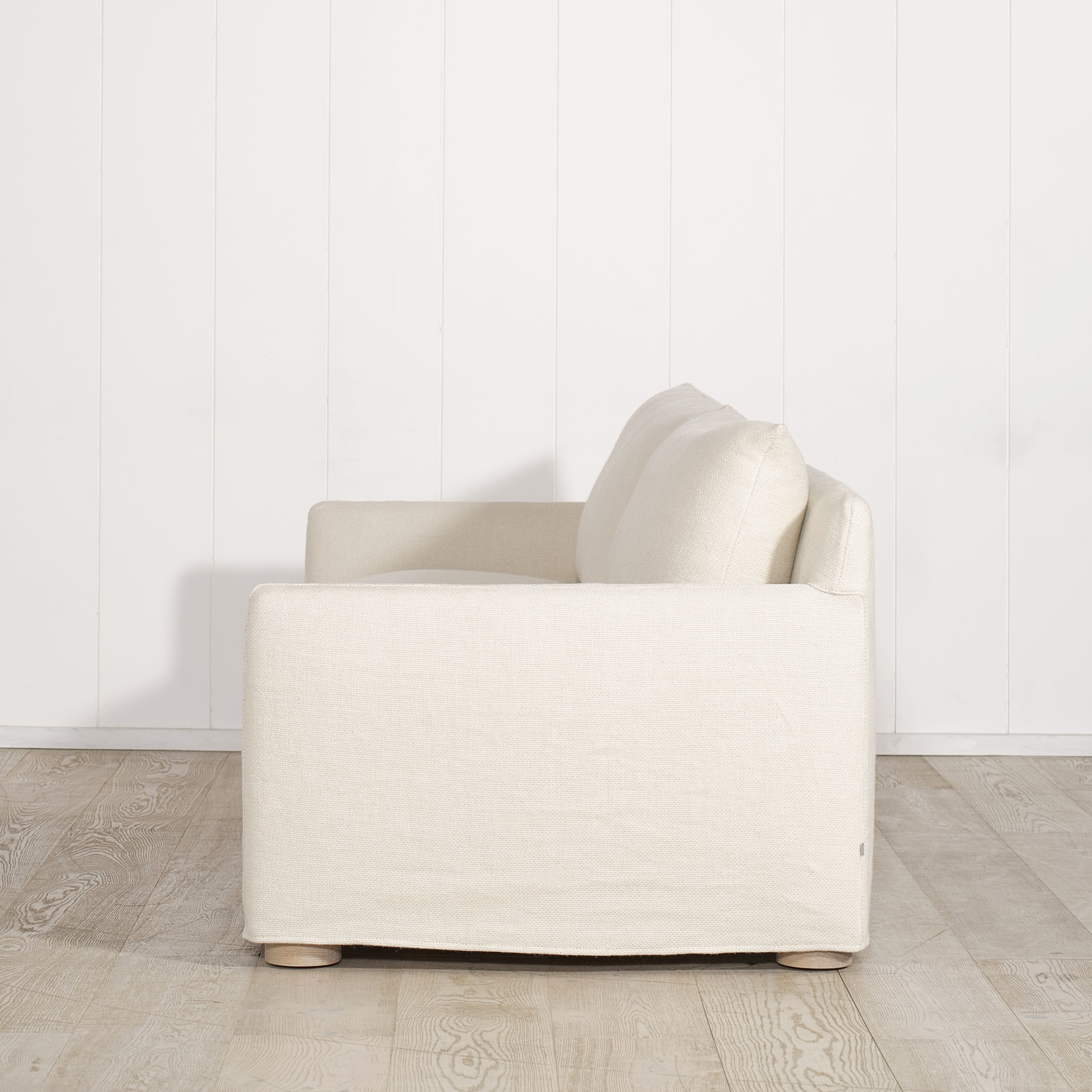 As Shown: Slipcovered in Monte Natural with legs finishing in Mint White Natural