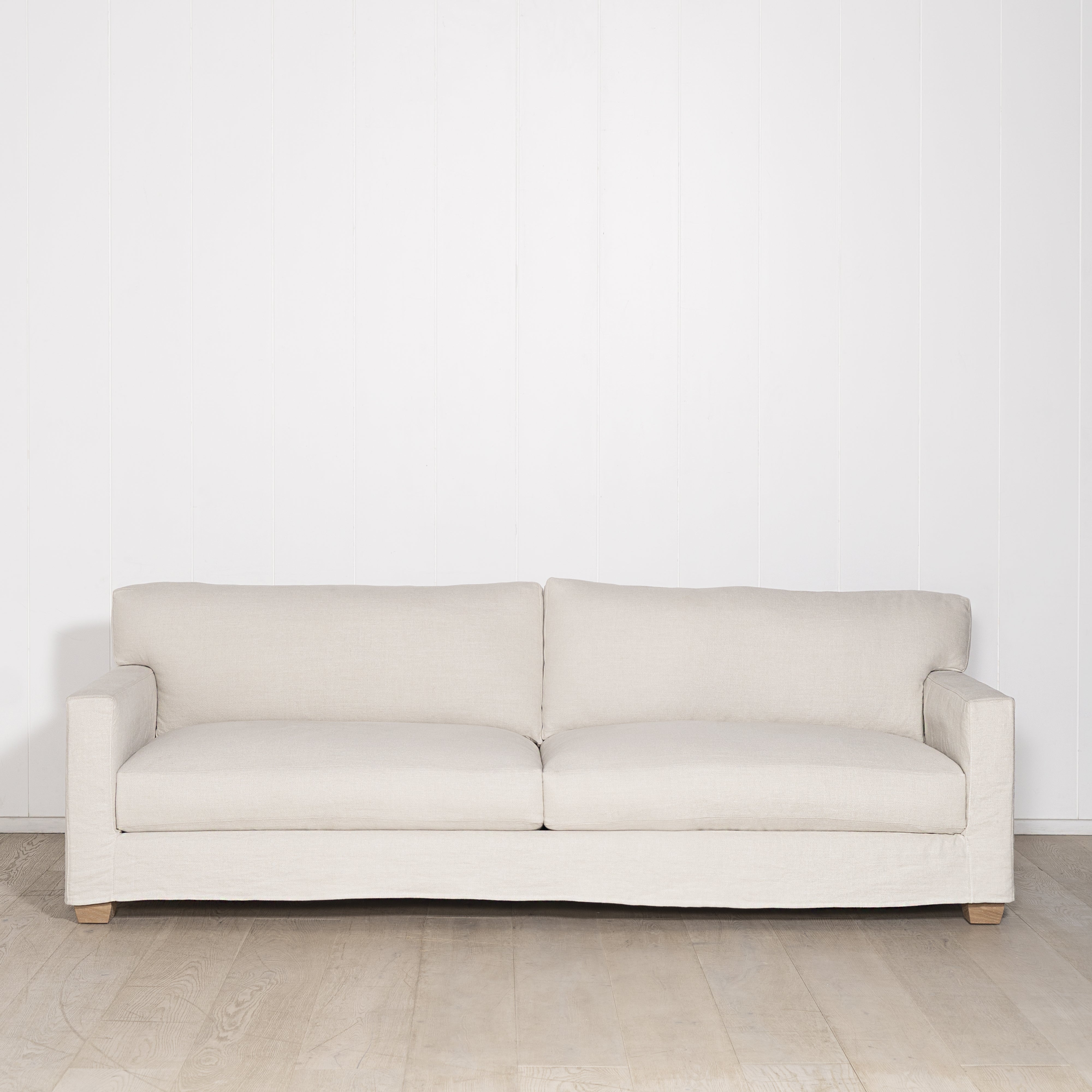 As Shown: in Large, short slipcovered in Fresno Sand, oak legs in custom finish