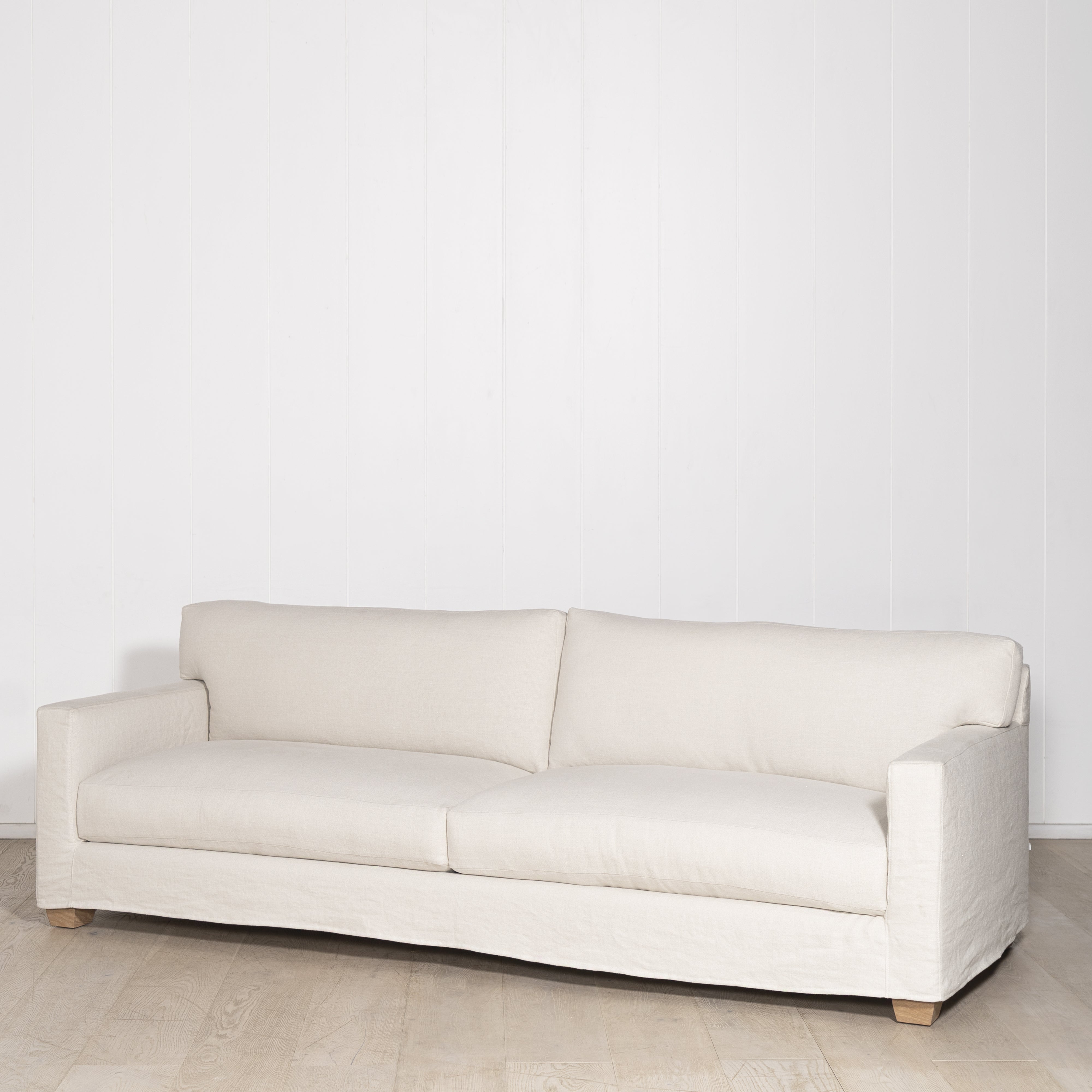 As Shown: in Large, short slipcovered in Fresno Sand, oak legs in custom finish