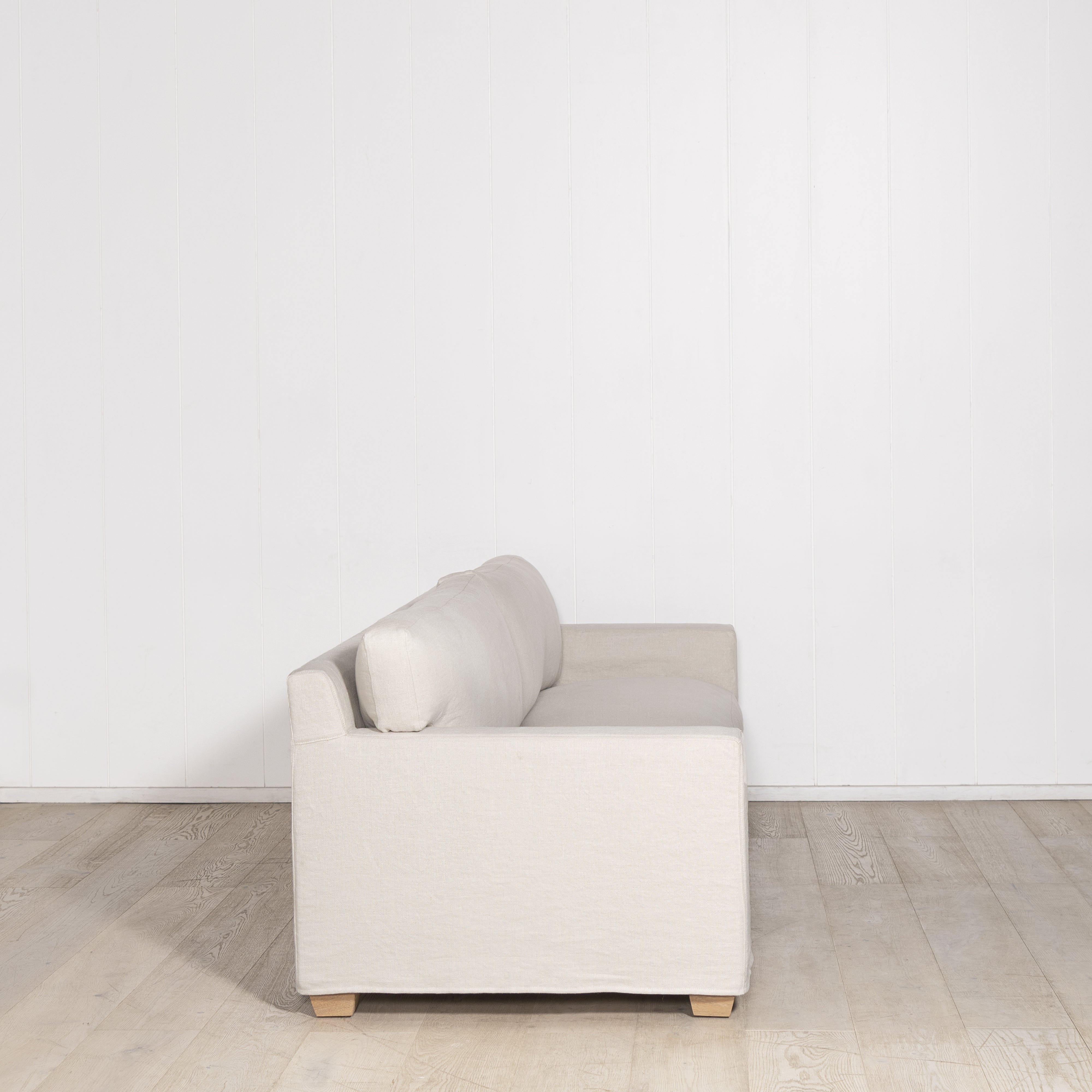 As Shown: in Large, short slipcovered in Fresno Sand, oak legs in custom finish