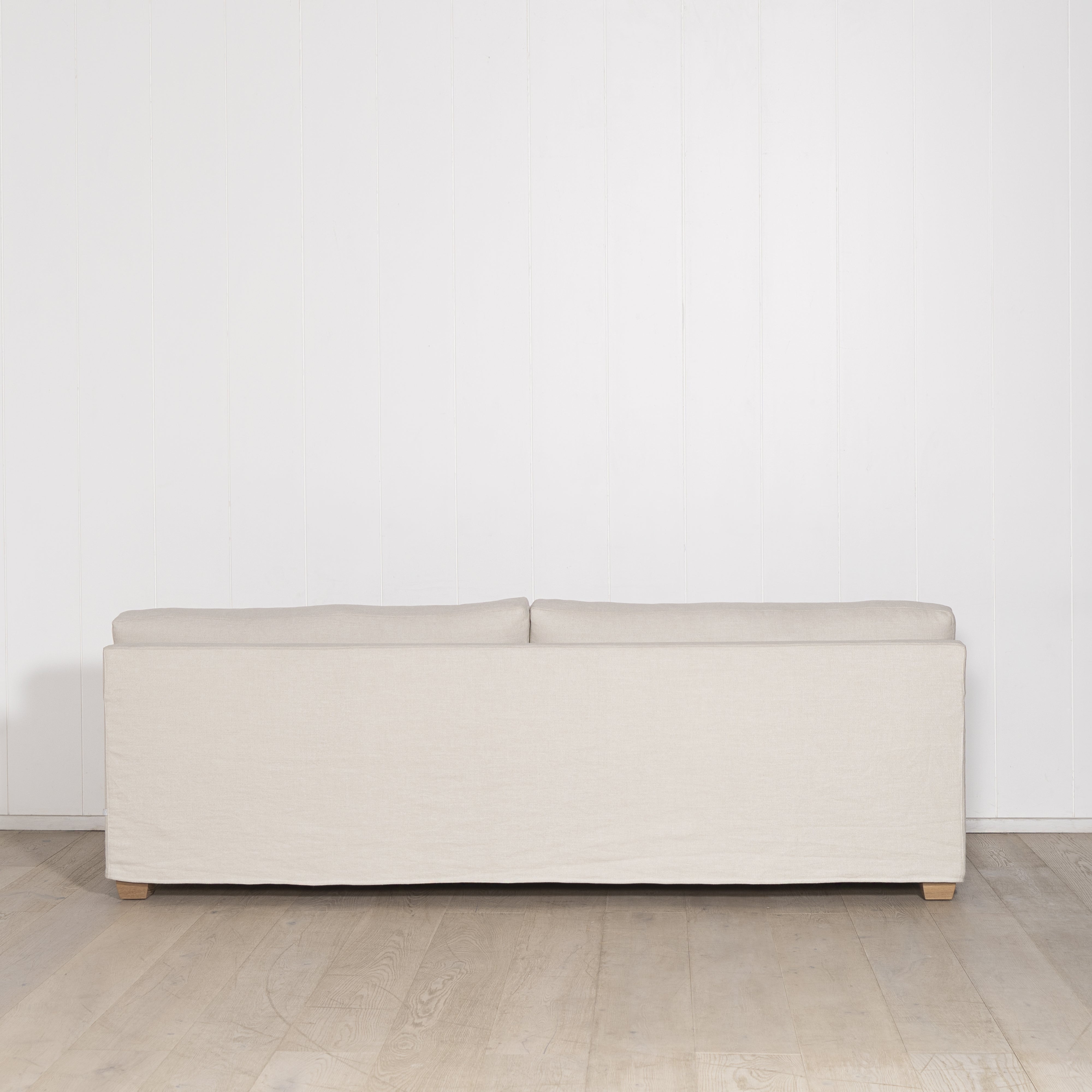 As Shown: in Large, short slipcovered in Fresno Sand, oak legs in custom finish