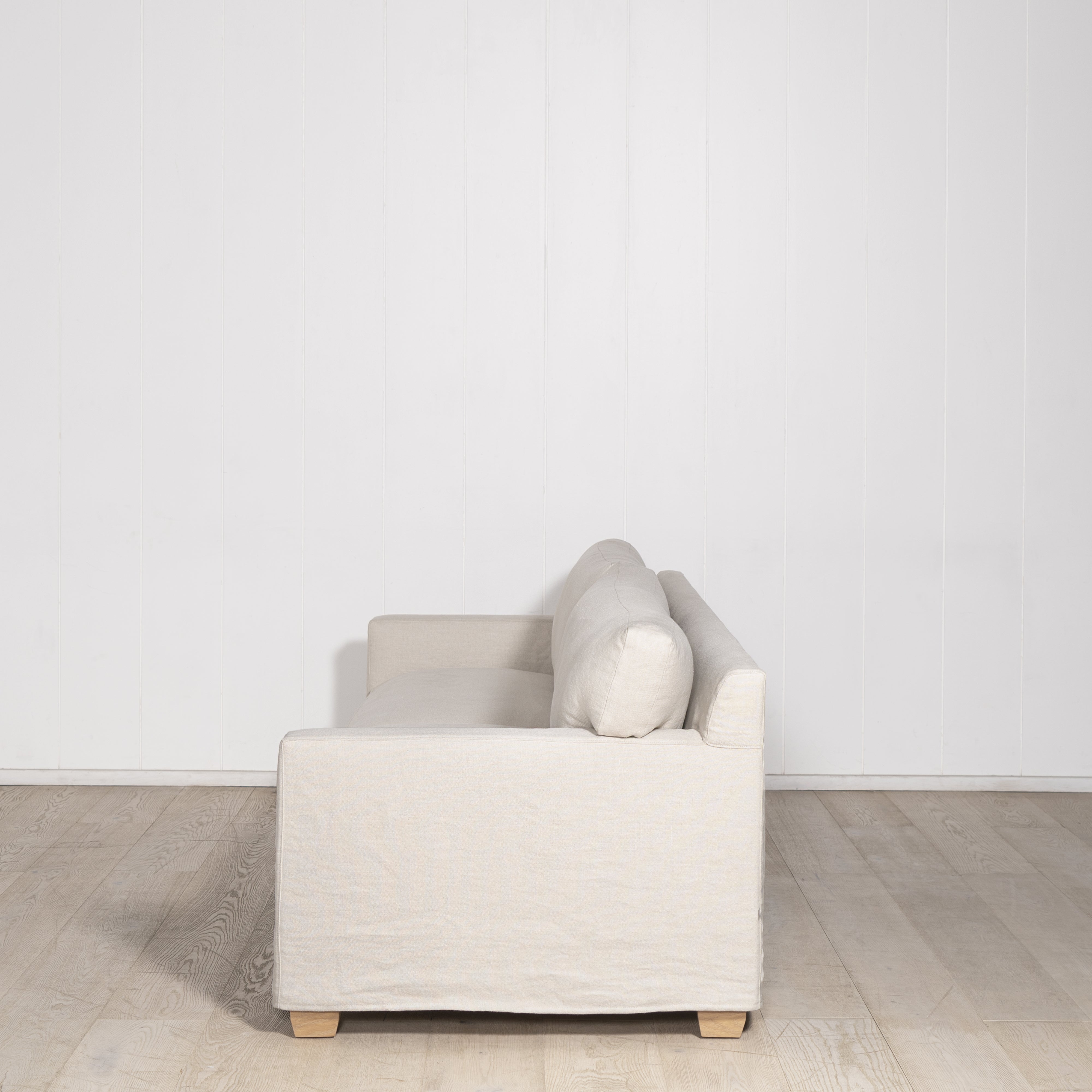 As Shown: in Large, short slipcovered in Fresno Sand, oak legs in custom finish