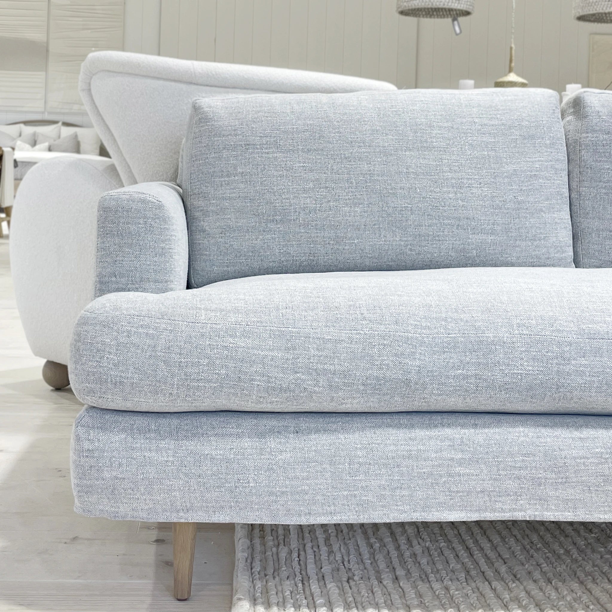 As Shown: Slipcovered in COM. Oak legs finished in Mint White Natural.