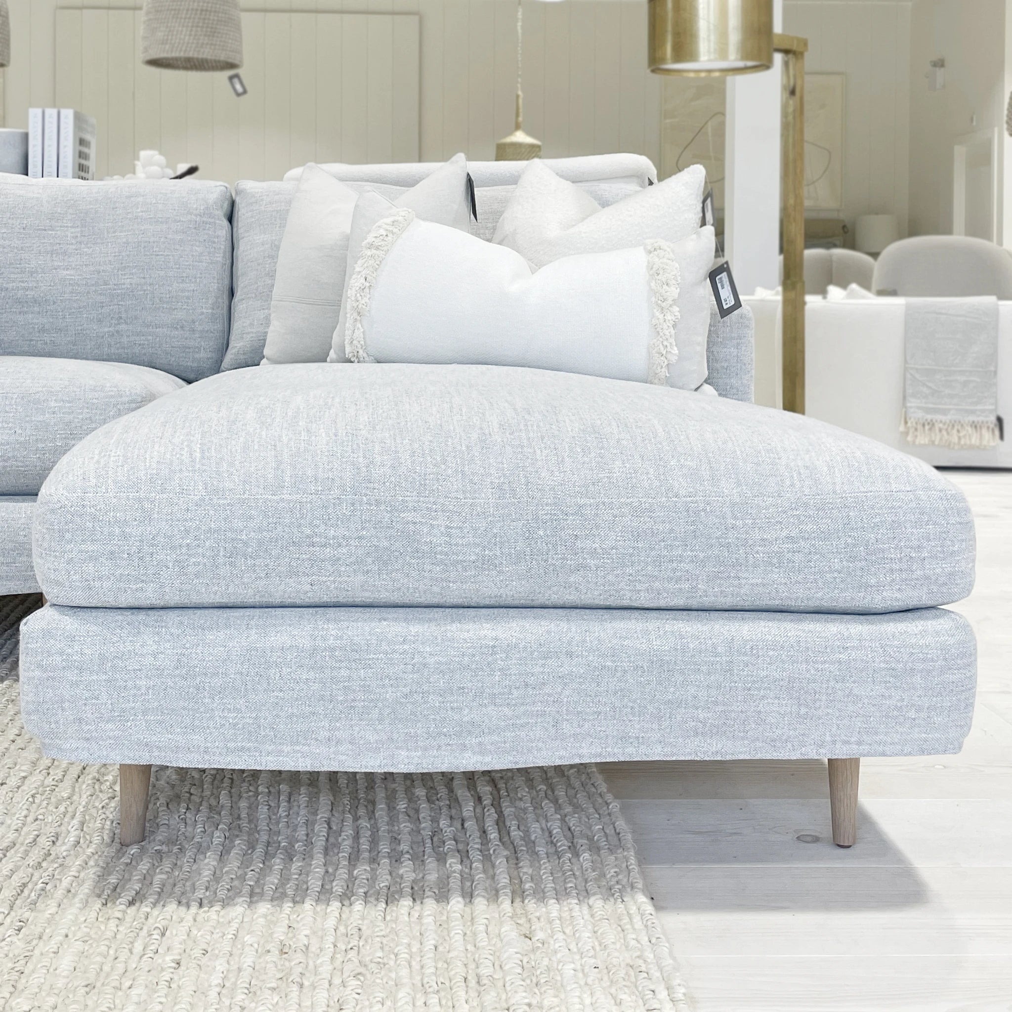 As Shown: Slipcovered in COM. Oak legs finished in Mint White Natural.