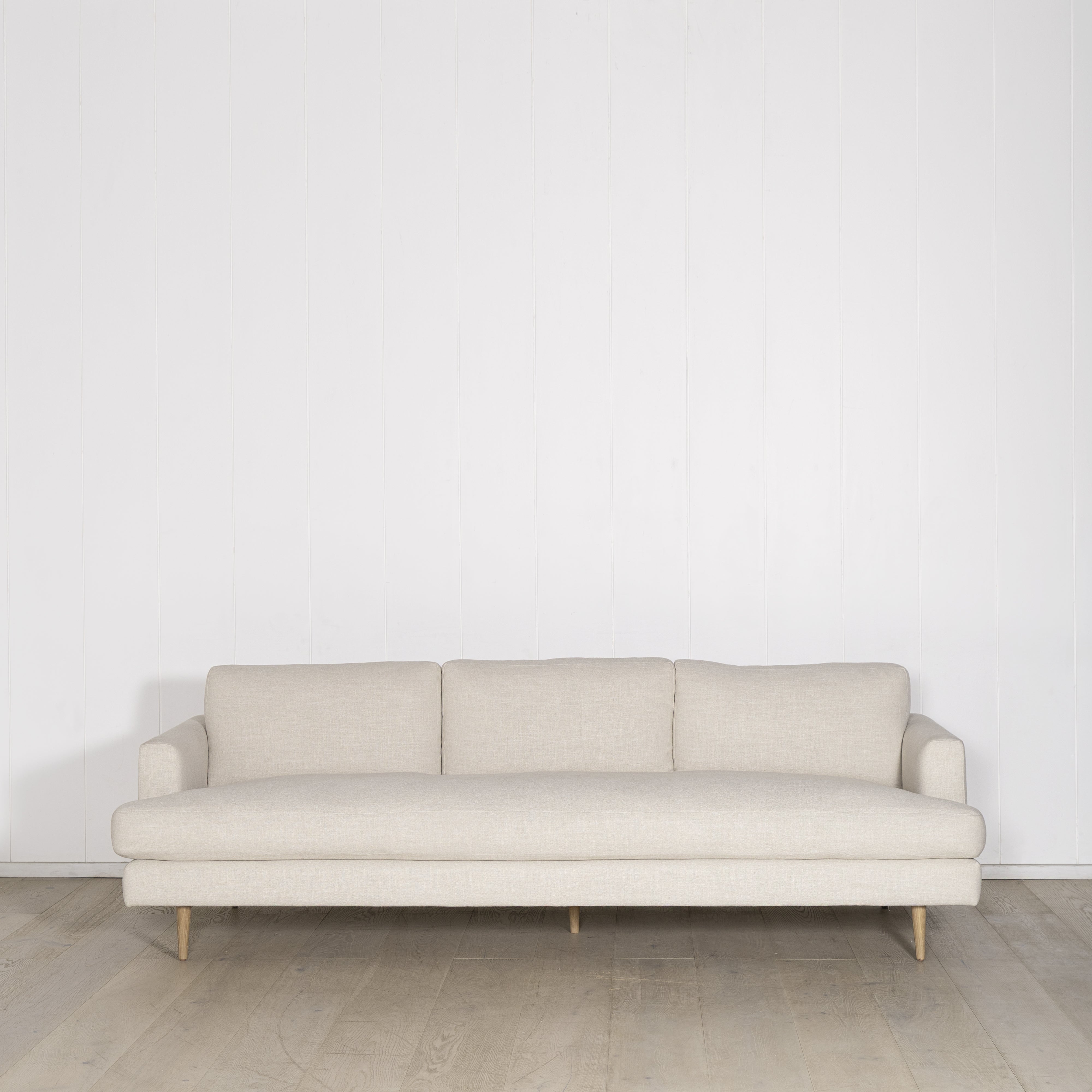As Shown: Medium, Upholstered in Belgian Oatmeal with legs finished in Mint White Natural.