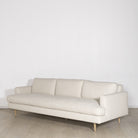 As Shown: Medium, Upholstered in Belgian Oatmeal with legs finished in Mint White Natural.
