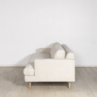 As Shown: Medium, Upholstered in Belgian Oatmeal with legs finished in Mint White Natural.