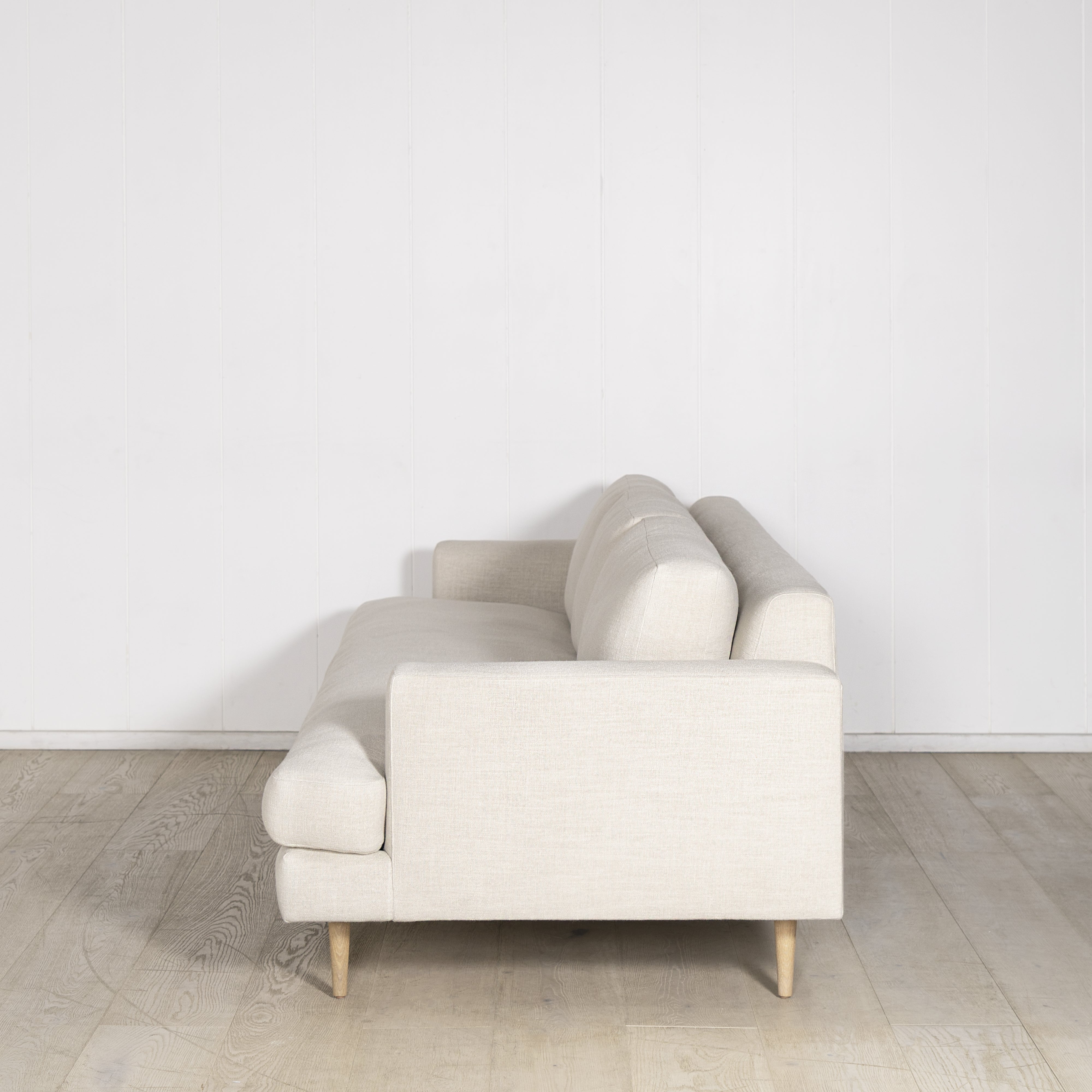 As Shown: Medium, Upholstered in Belgian Oatmeal with legs finished in Mint White Natural.