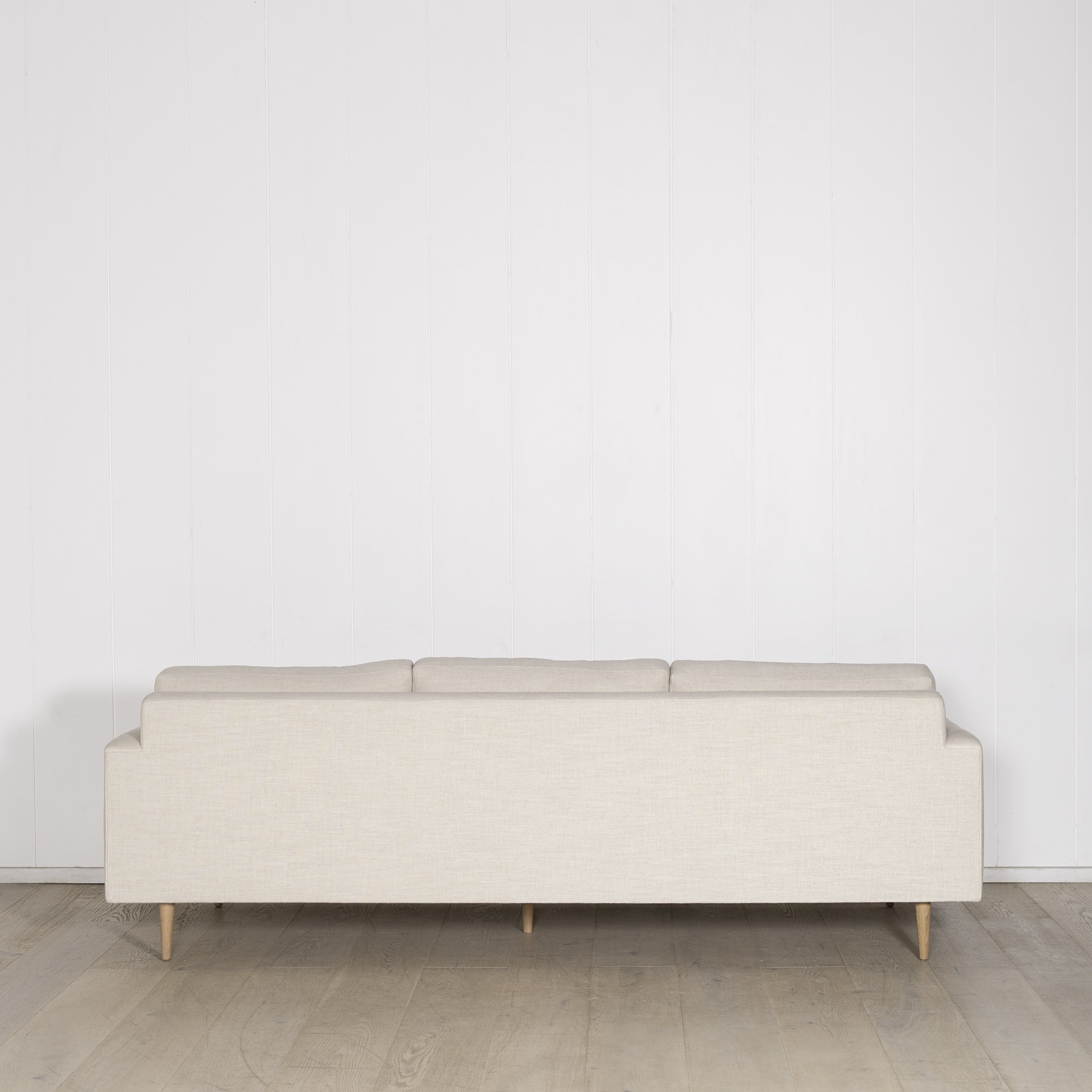 As Shown: Medium, Upholstered in Belgian Oatmeal with legs finished in Mint White Natural.