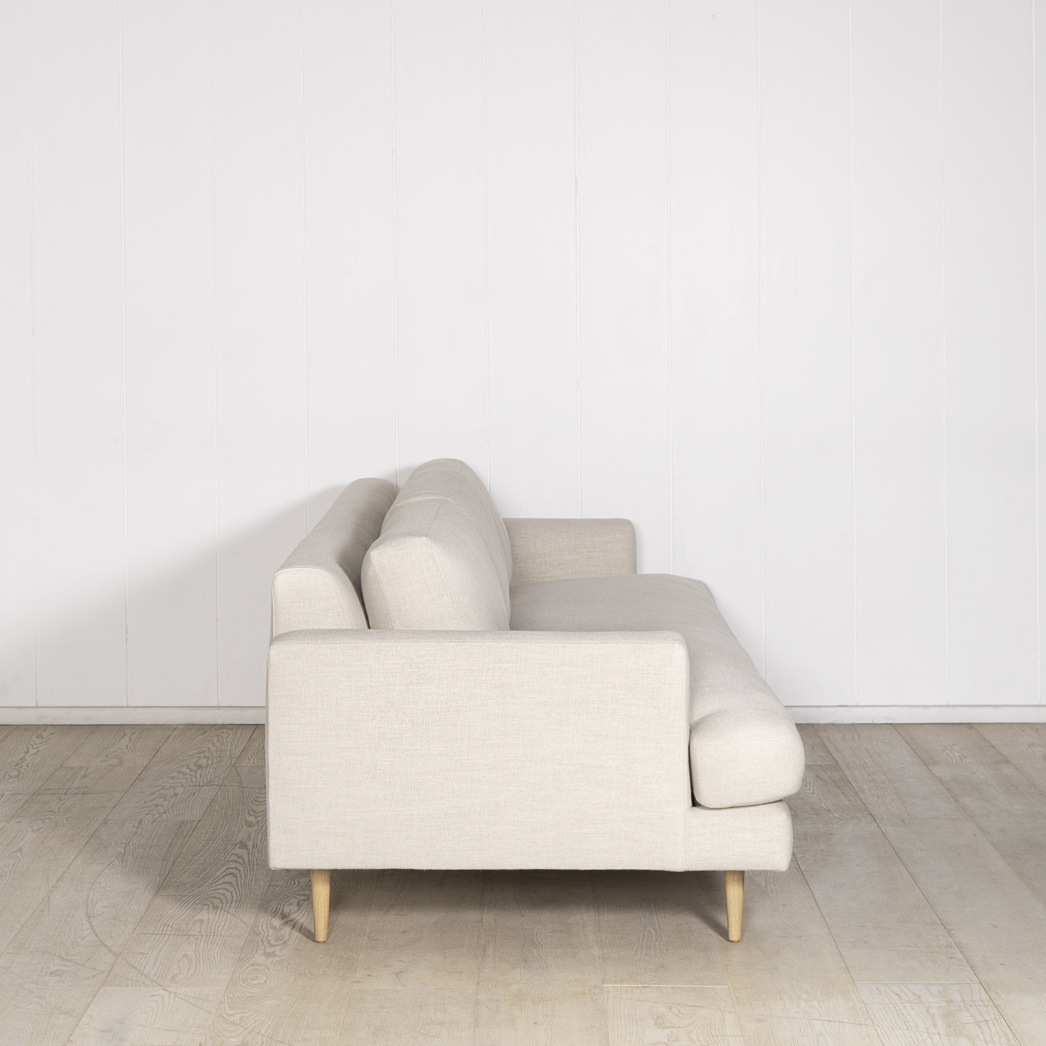 As Shown: Medium, Upholstered in Belgian Oatmeal with legs finished in Mint White Natural.