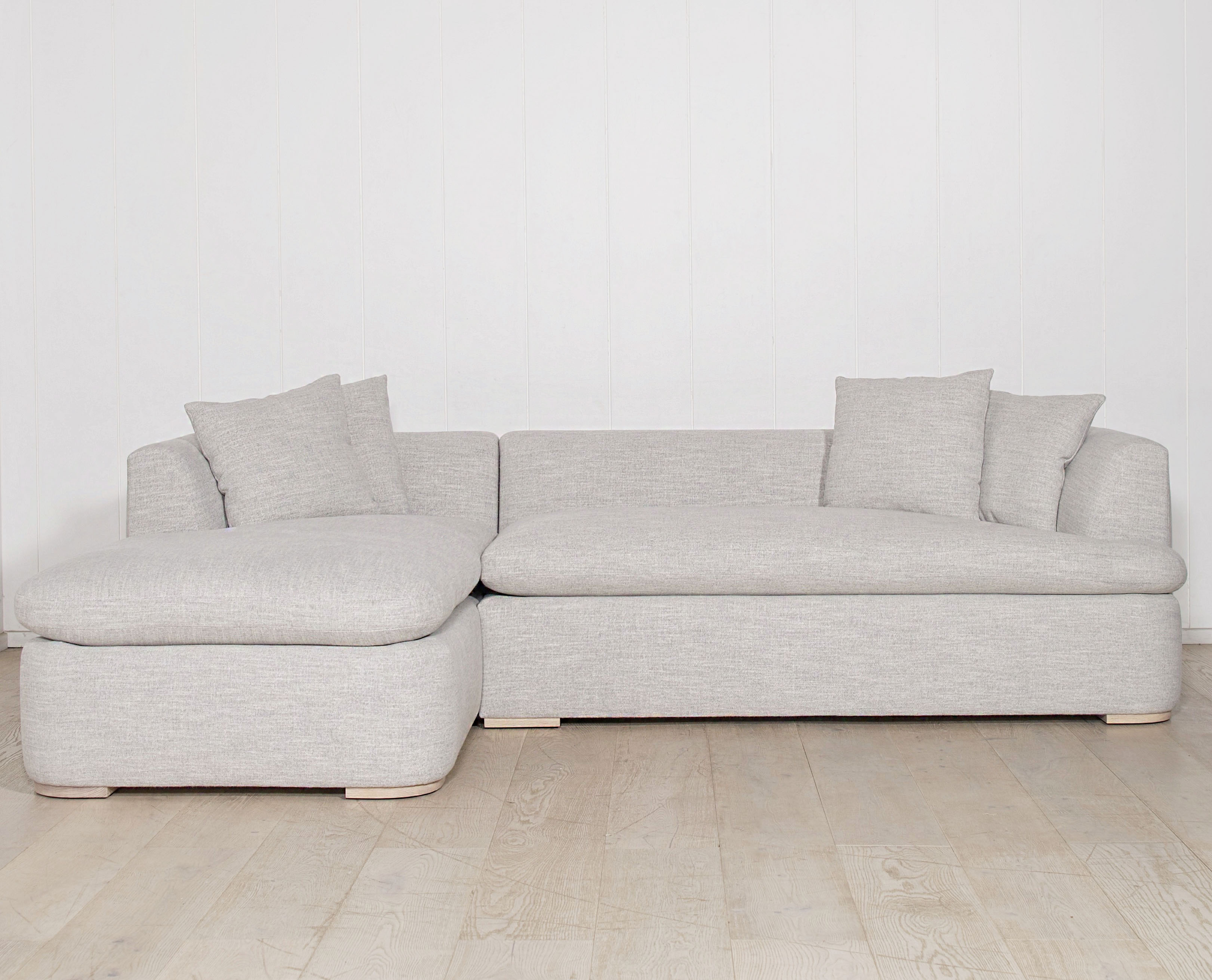 As Shown: Upholstered in COM with Lincoln Parchment seat cushions and pillows. Last variant  in Belgian Sky Blue.Oak legs finished in Mint White Natural.
