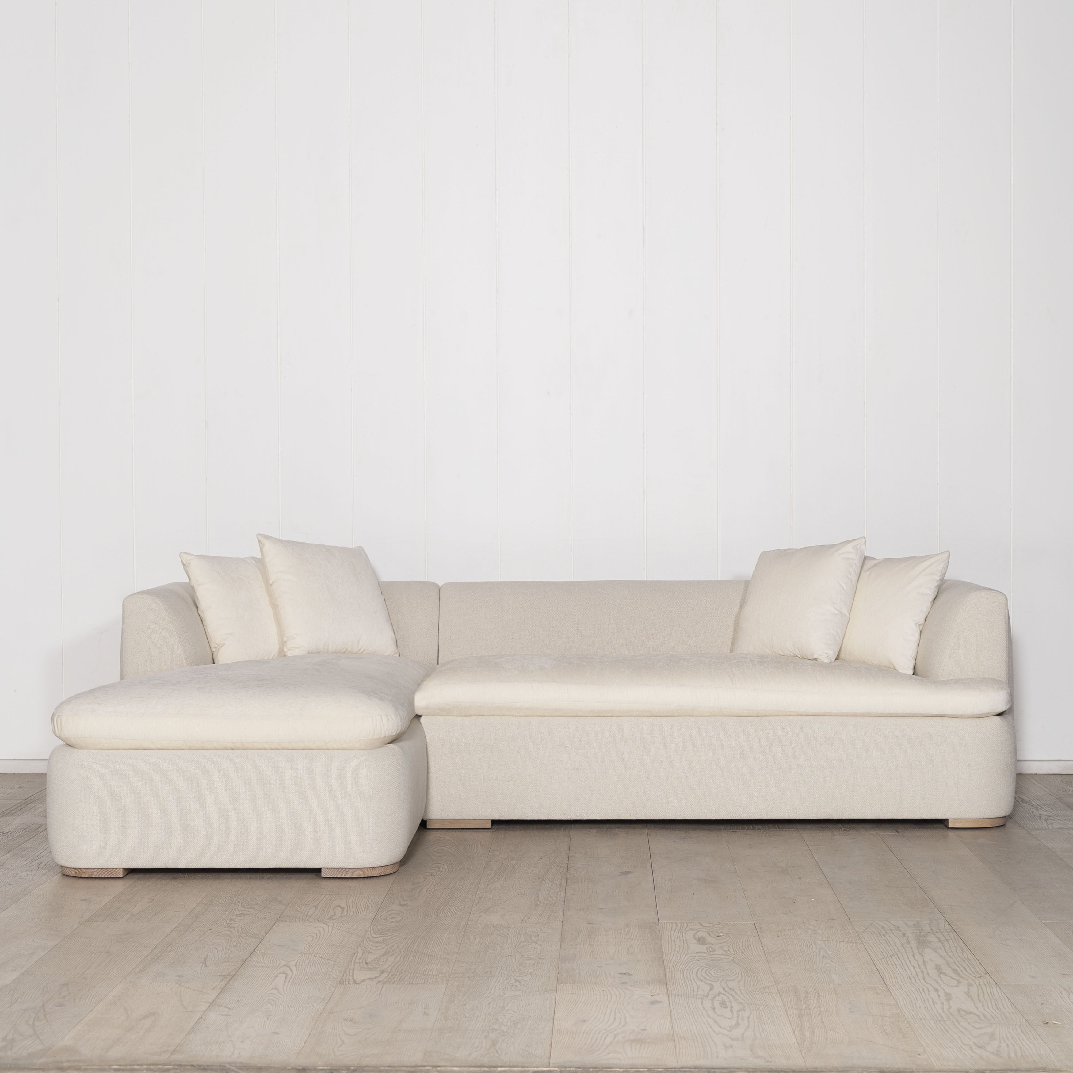 As Shown: Upholstered in COM with Lincoln Parchment seat cushions and pillows. Last variant  in Belgian Sky Blue.Oak legs finished in Mint White Natural.