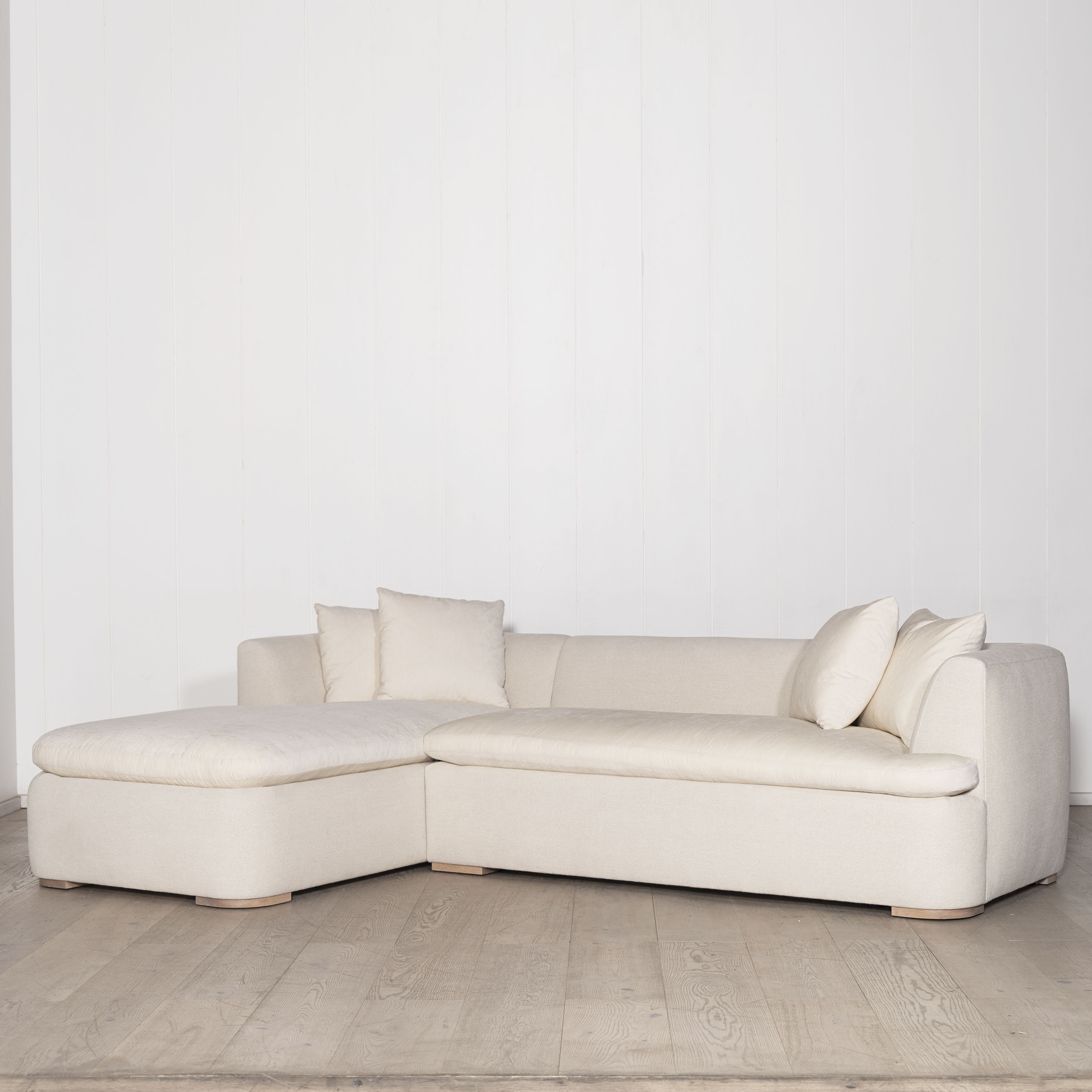 As Shown: Upholstered in COM with Lincoln Parchment seat cushions and pillows. Last variant  in Belgian Sky Blue.Oak legs finished in Mint White Natural.