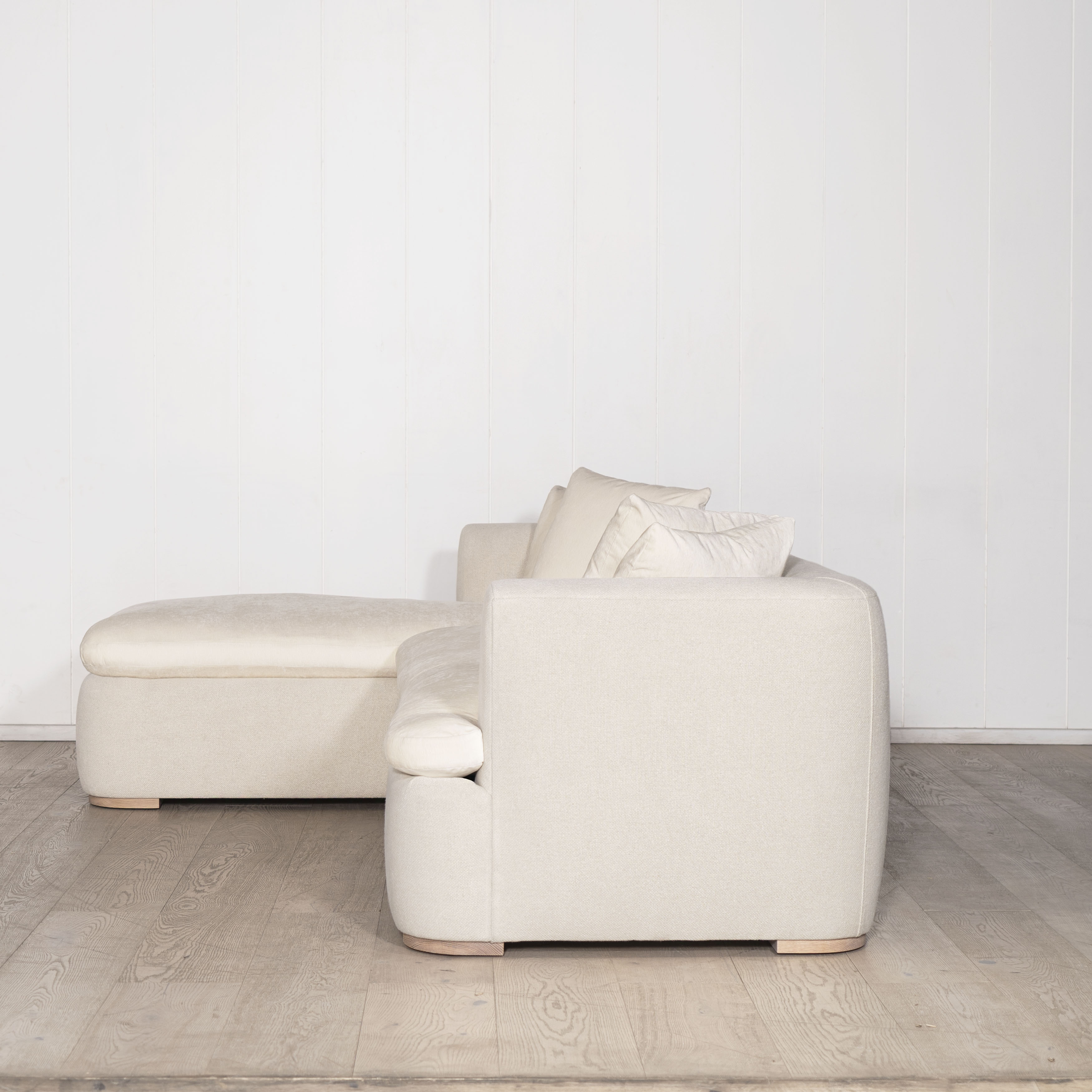 As Shown: Upholstered in COM with Lincoln Parchment seat cushions and pillows. Last variant  in Belgian Sky Blue.Oak legs finished in Mint White Natural.
