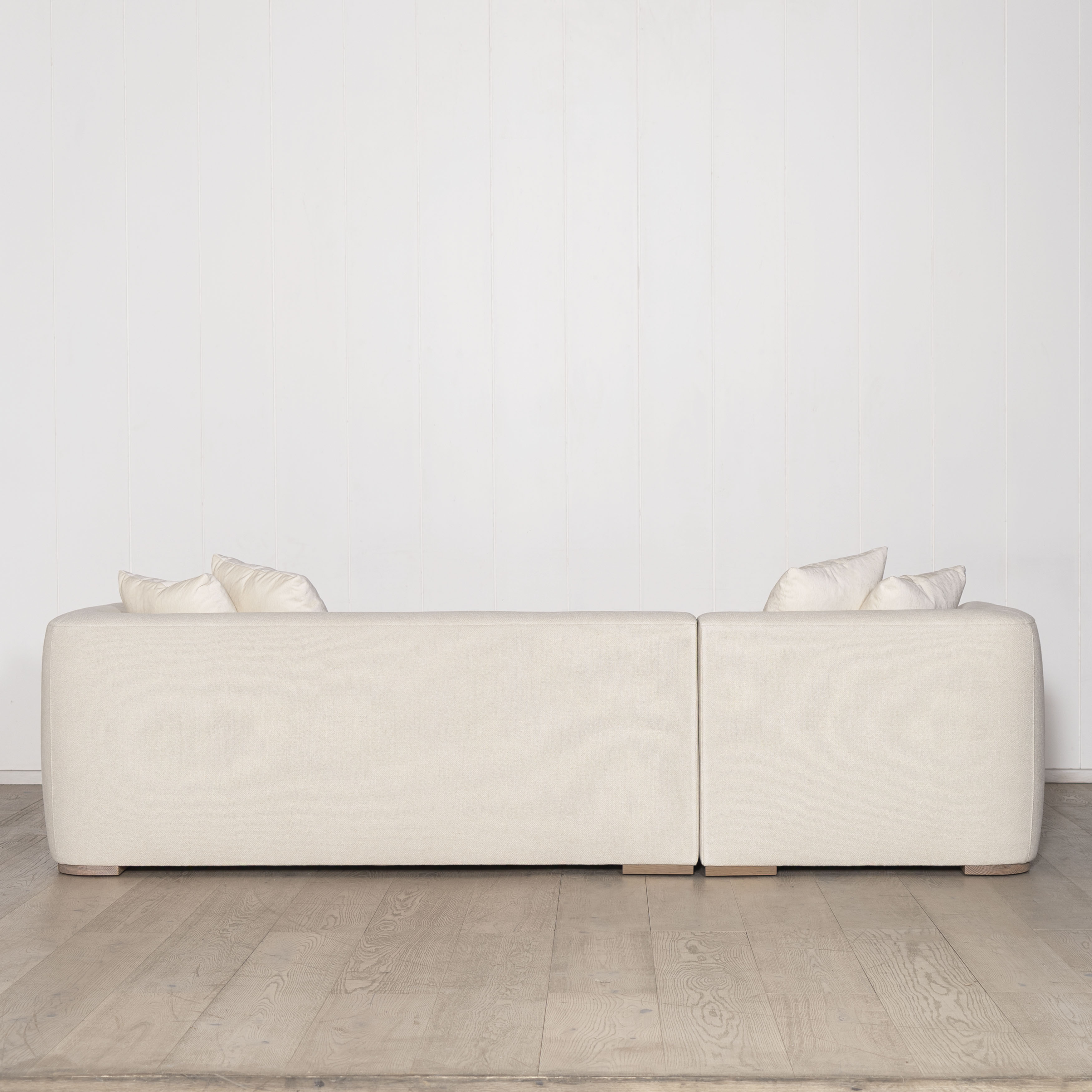 As Shown: Upholstered in COM with Lincoln Parchment seat cushions and pillows. Last variant  in Belgian Sky Blue.Oak legs finished in Mint White Natural.