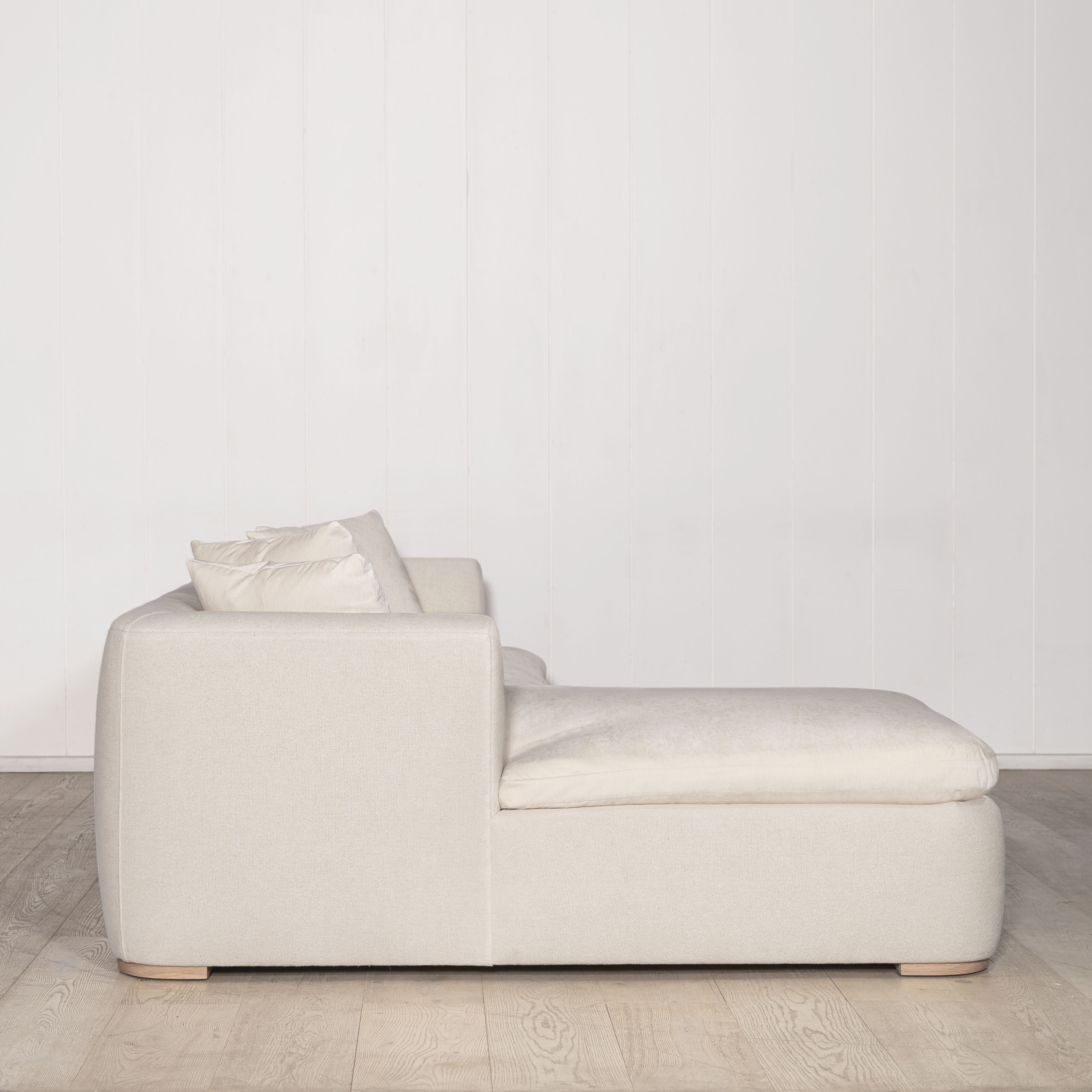 As Shown: Upholstered in COM with Lincoln Parchment seat cushions and pillows. Last variant  in Belgian Sky Blue.Oak legs finished in Mint White Natural.