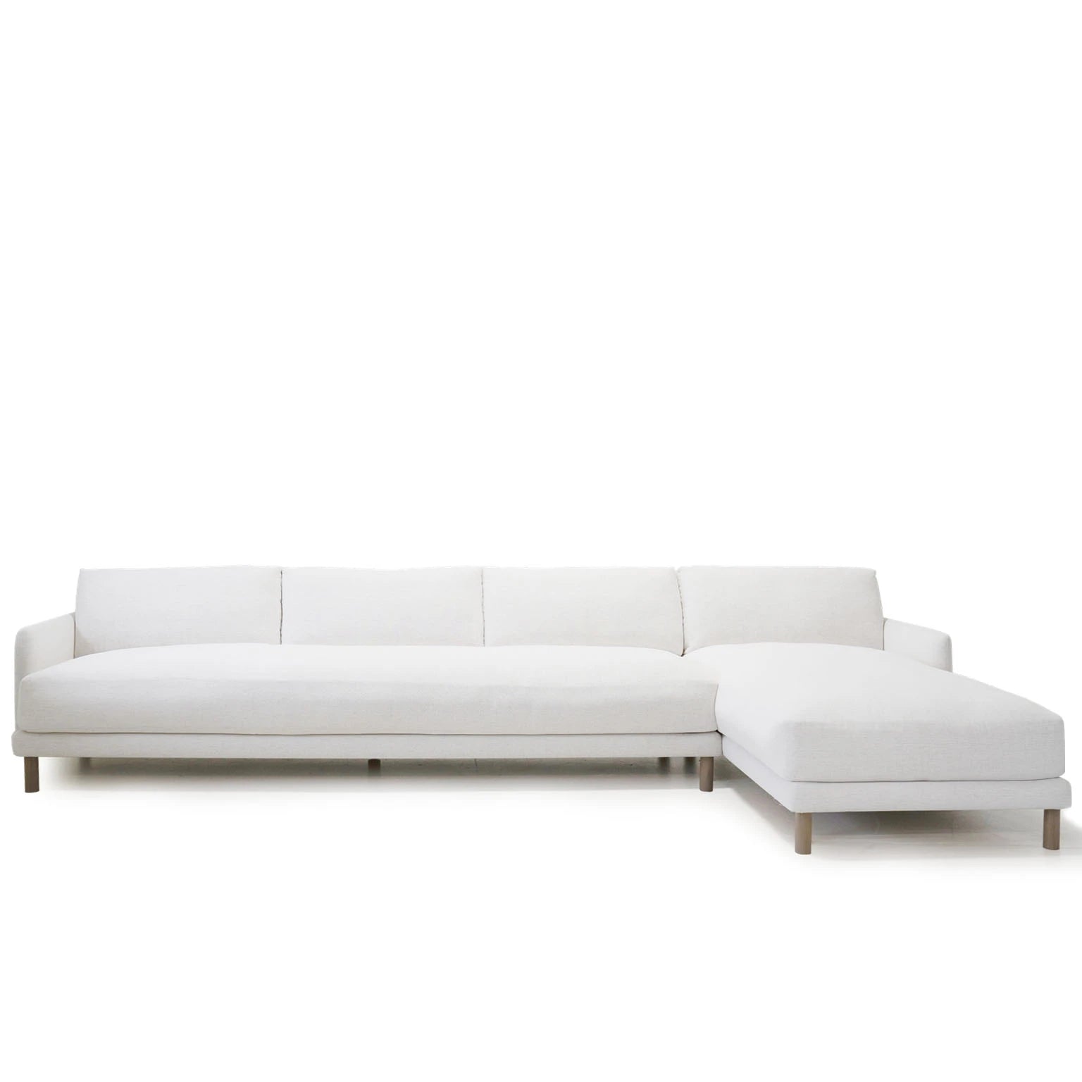 As Shown: in right chaise upholstered in Nomad Snow, oak legs finished in Antique Beige (Discontinued Finish)