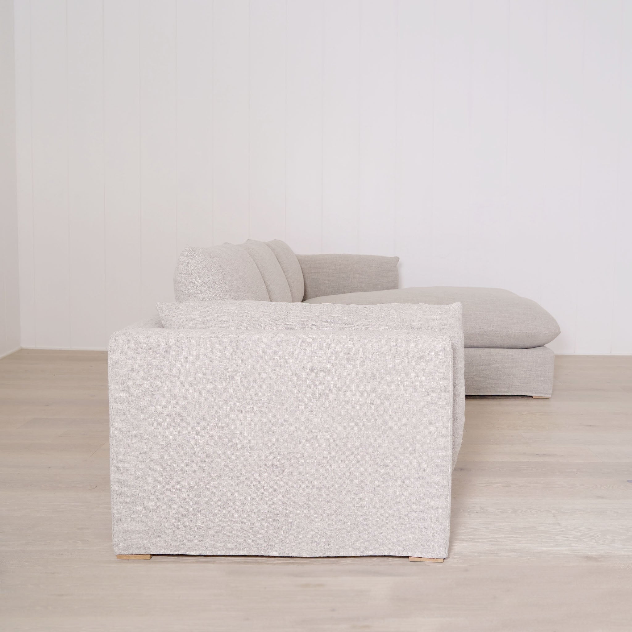 Shown in right chaise slipcovered Belgian Mulberry